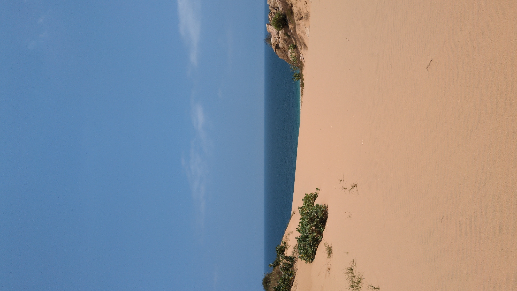 Person rests on Vietnam's Mui Dinh sand dunes morning