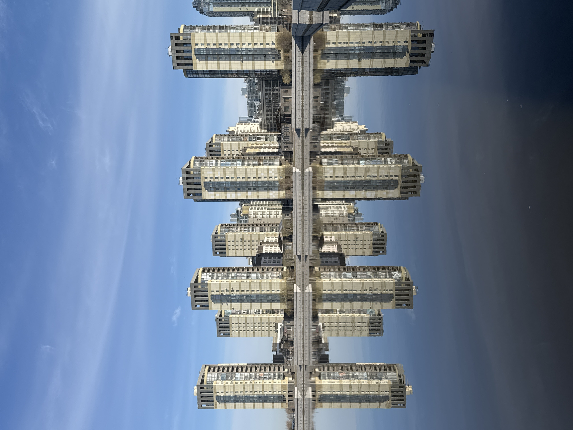 Morning reflection captures apartment buildings mirrored in Saint Petersburg waters