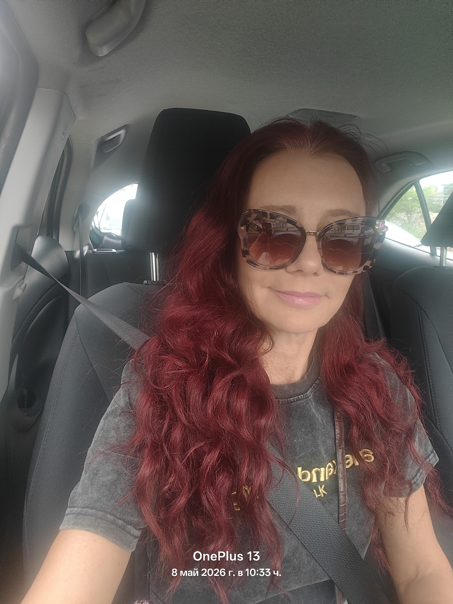 Woman with red hair spotted in car wearing seatbelt