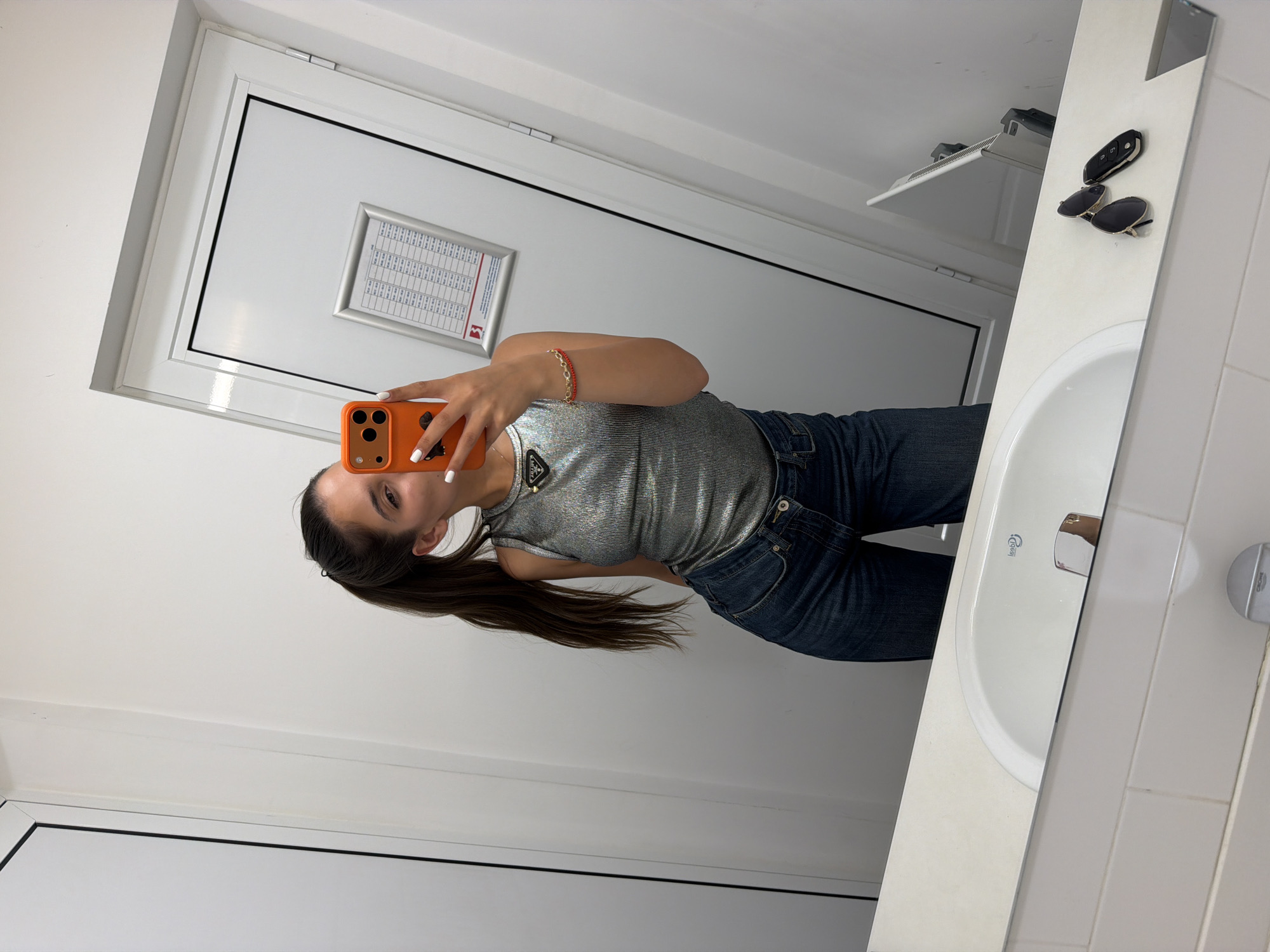 Woman takes bathroom mirror selfies in Pernik, Bulgaria