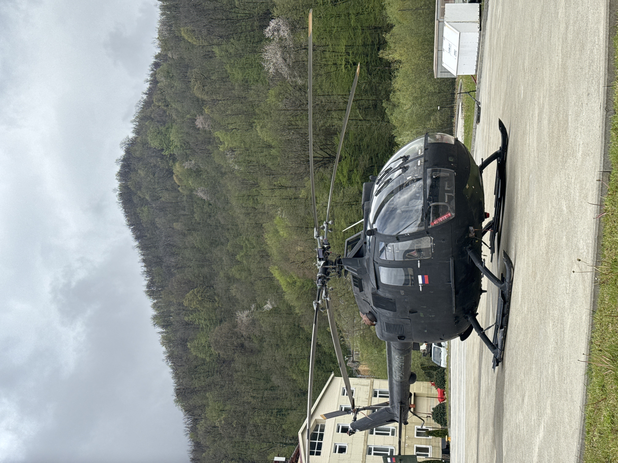 Dark helicopter parked at building complex in Estosadok, Russia