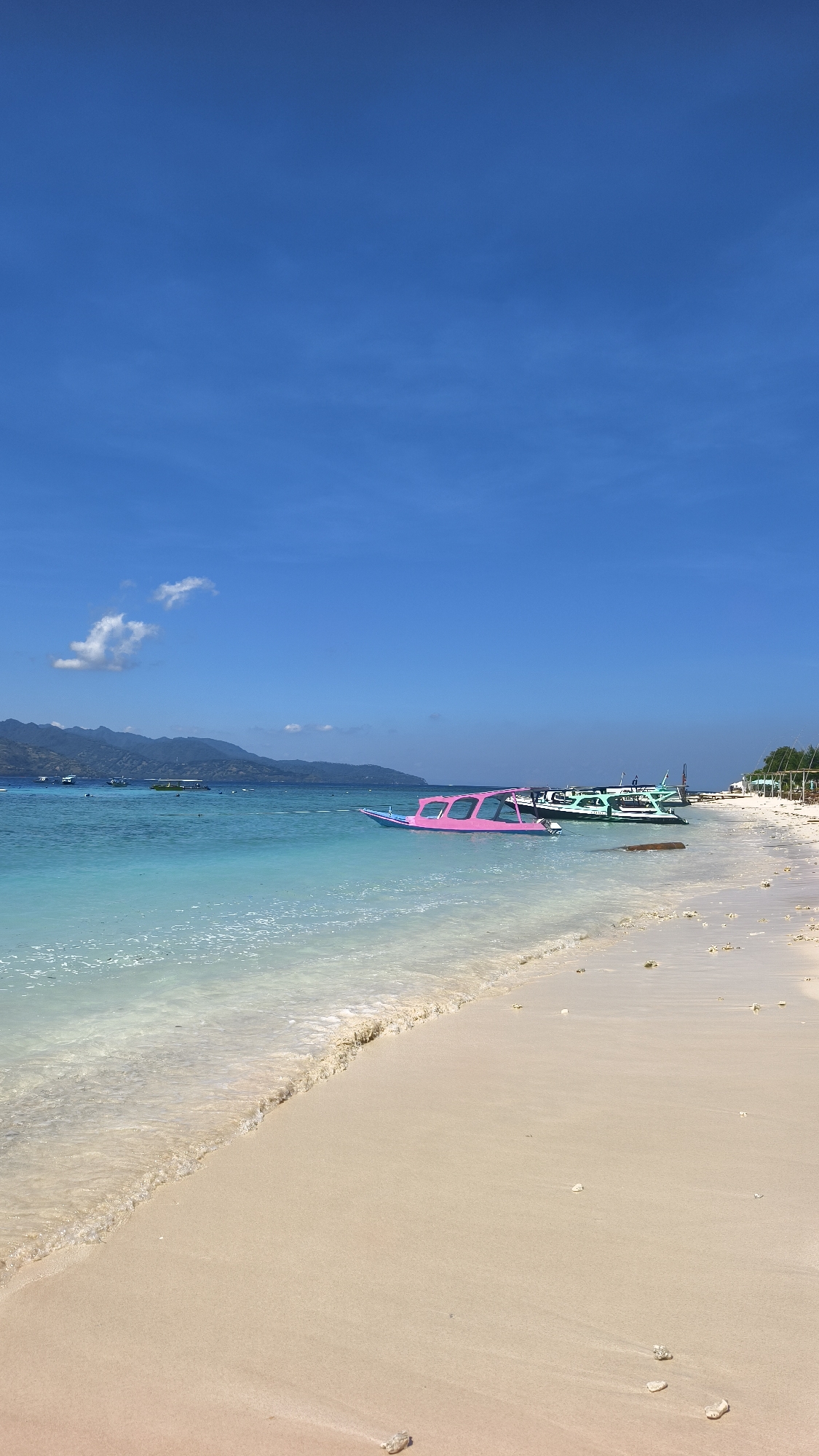 Tropical beach scene with boats documented in Indonesia