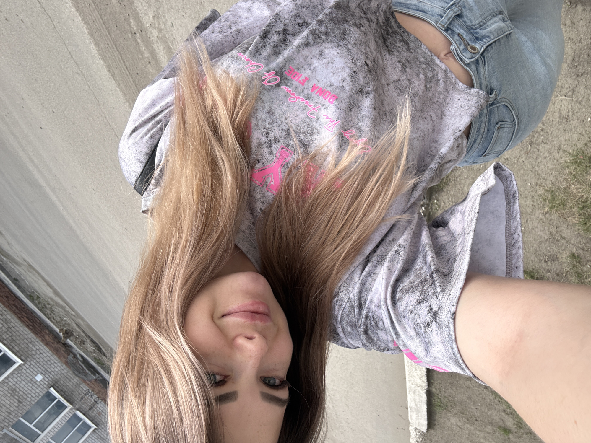 Woman takes selfie in tie-dye sweatshirt