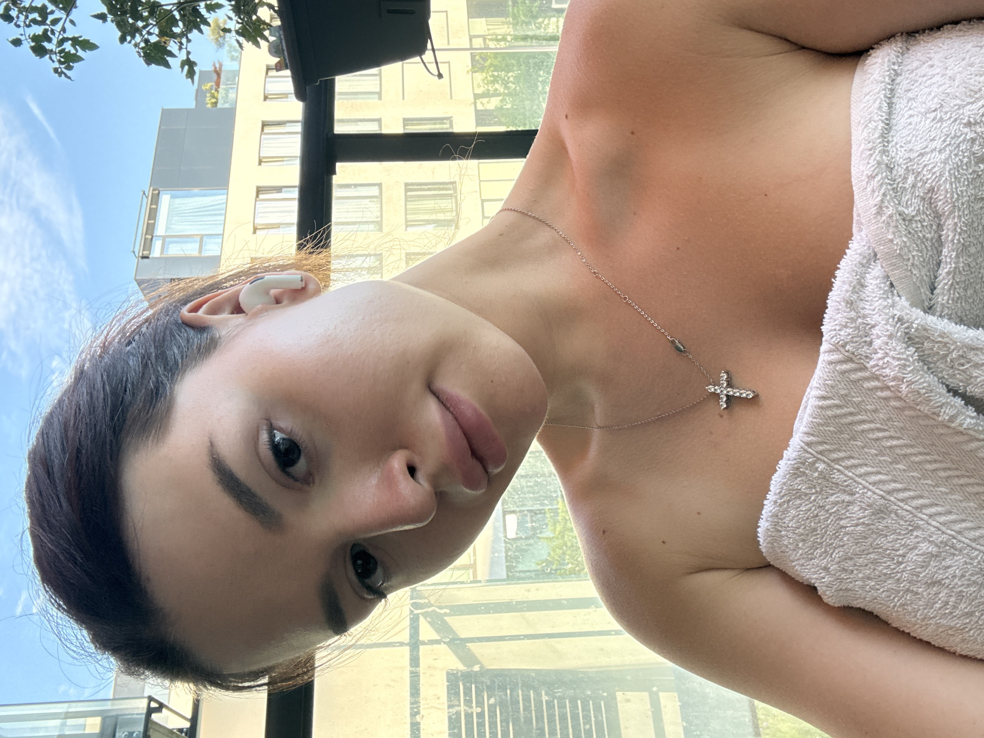Balcony selfie series in Prague, towel and earbuds on