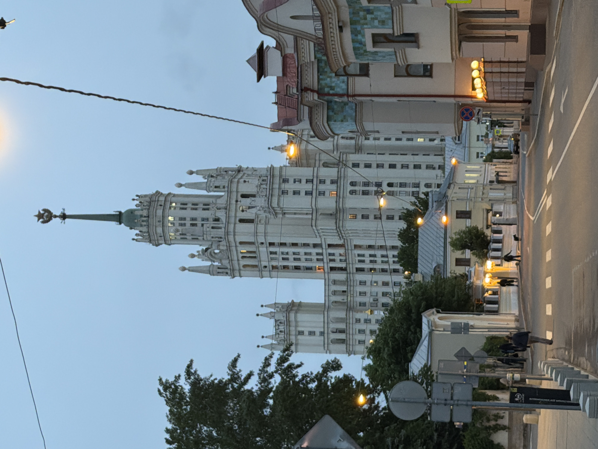Woman films herself near Moscow's Stalinist skyscraper at dusk