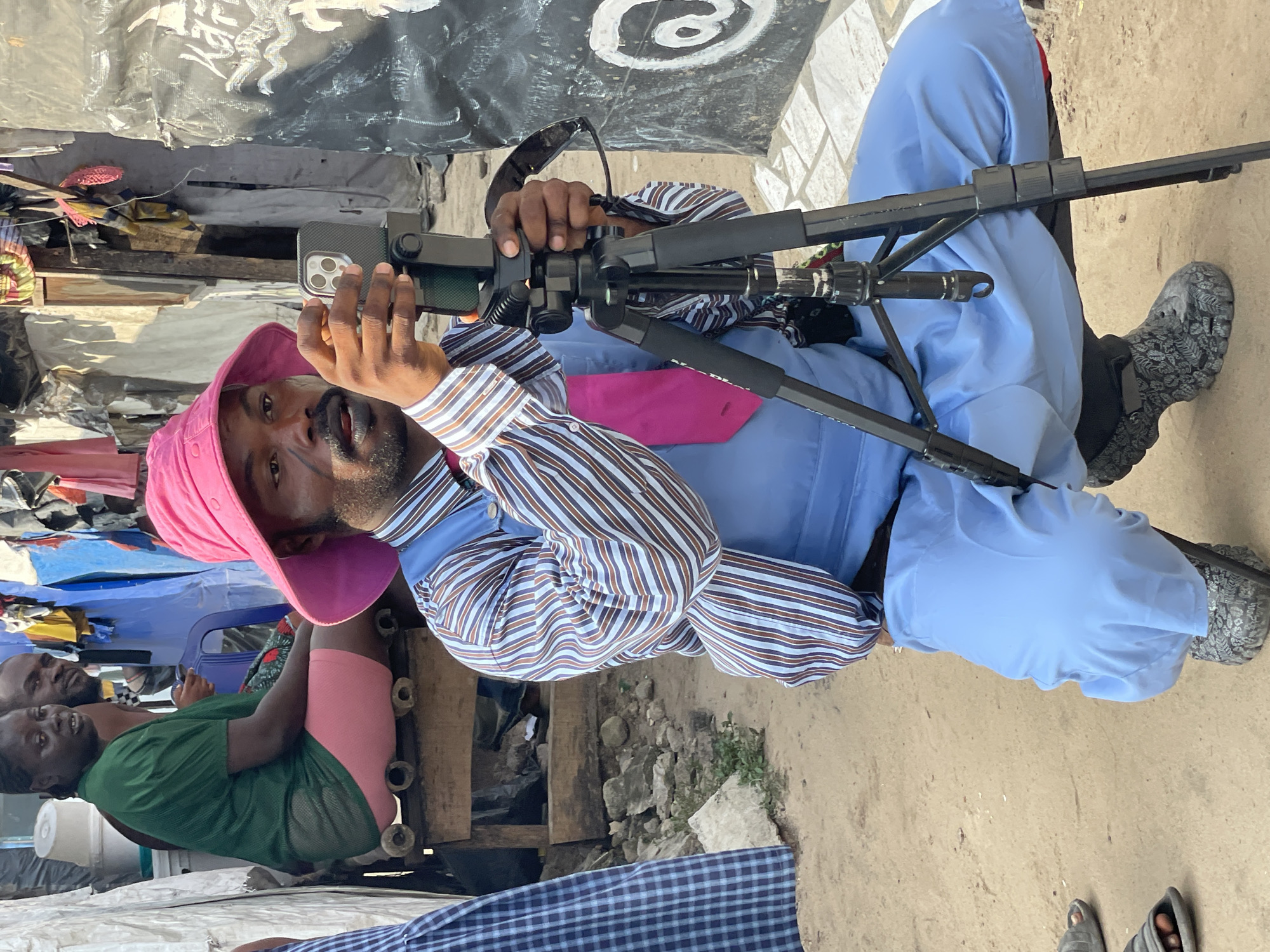 Man films with smartphone on tripod in Iranla, Nigeria