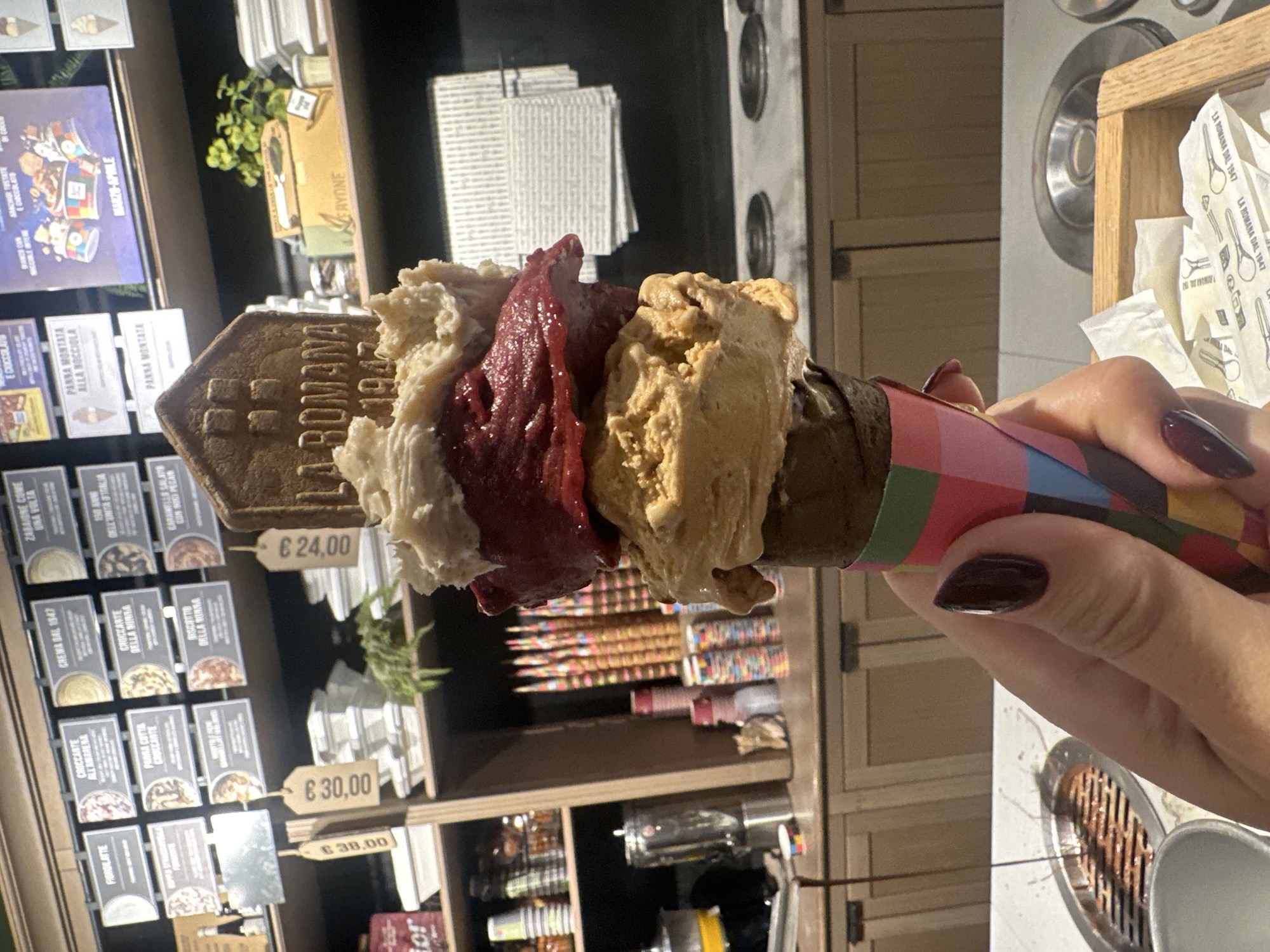 Customer enjoys gelato at Turin's Gelateria La Romana