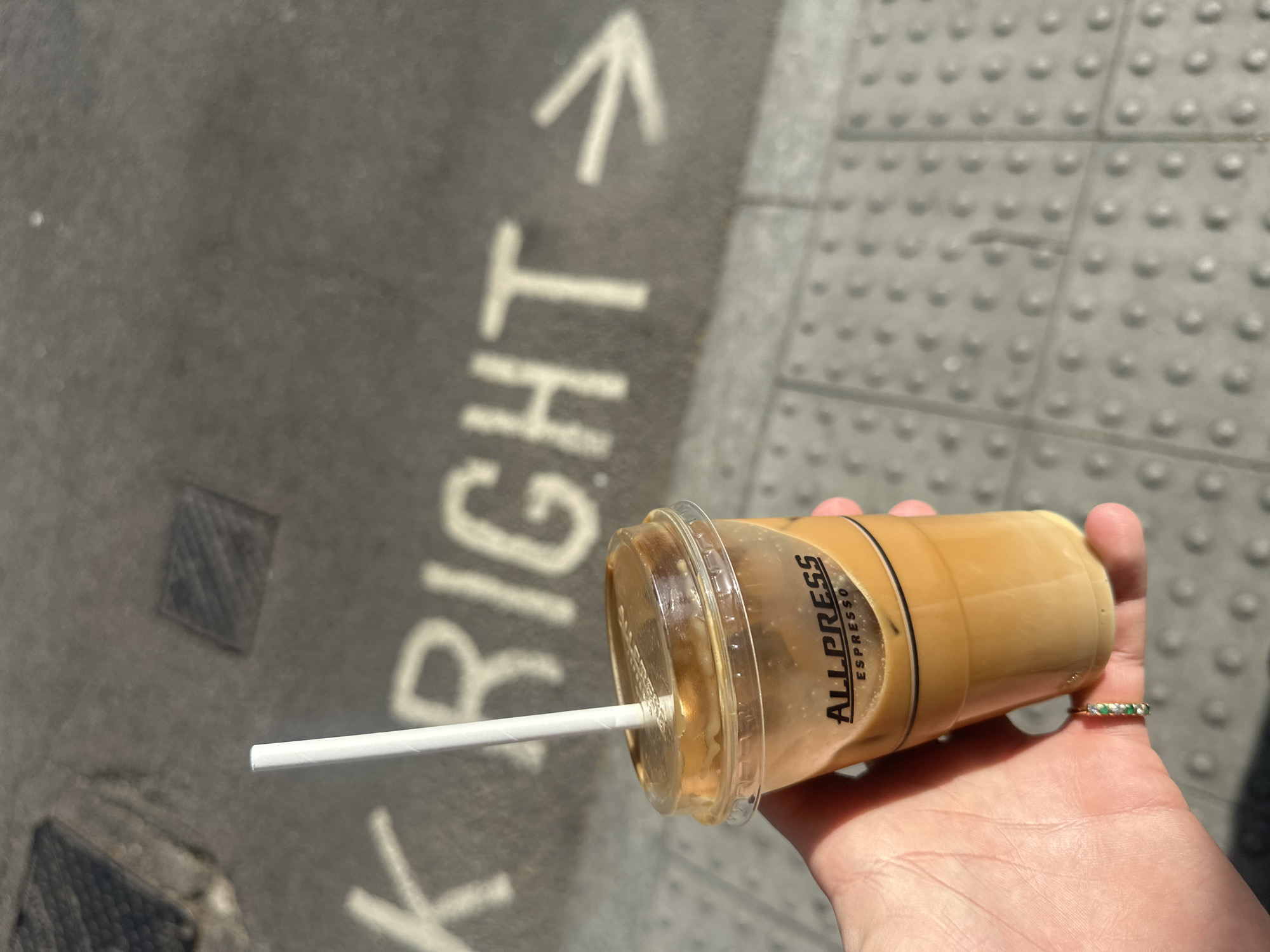 Coffee moment captured on marked London sidewalk