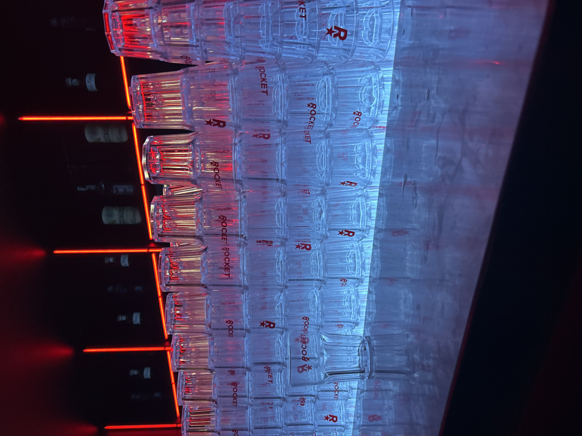 Bar setup with romantic neon signage documented in Milan