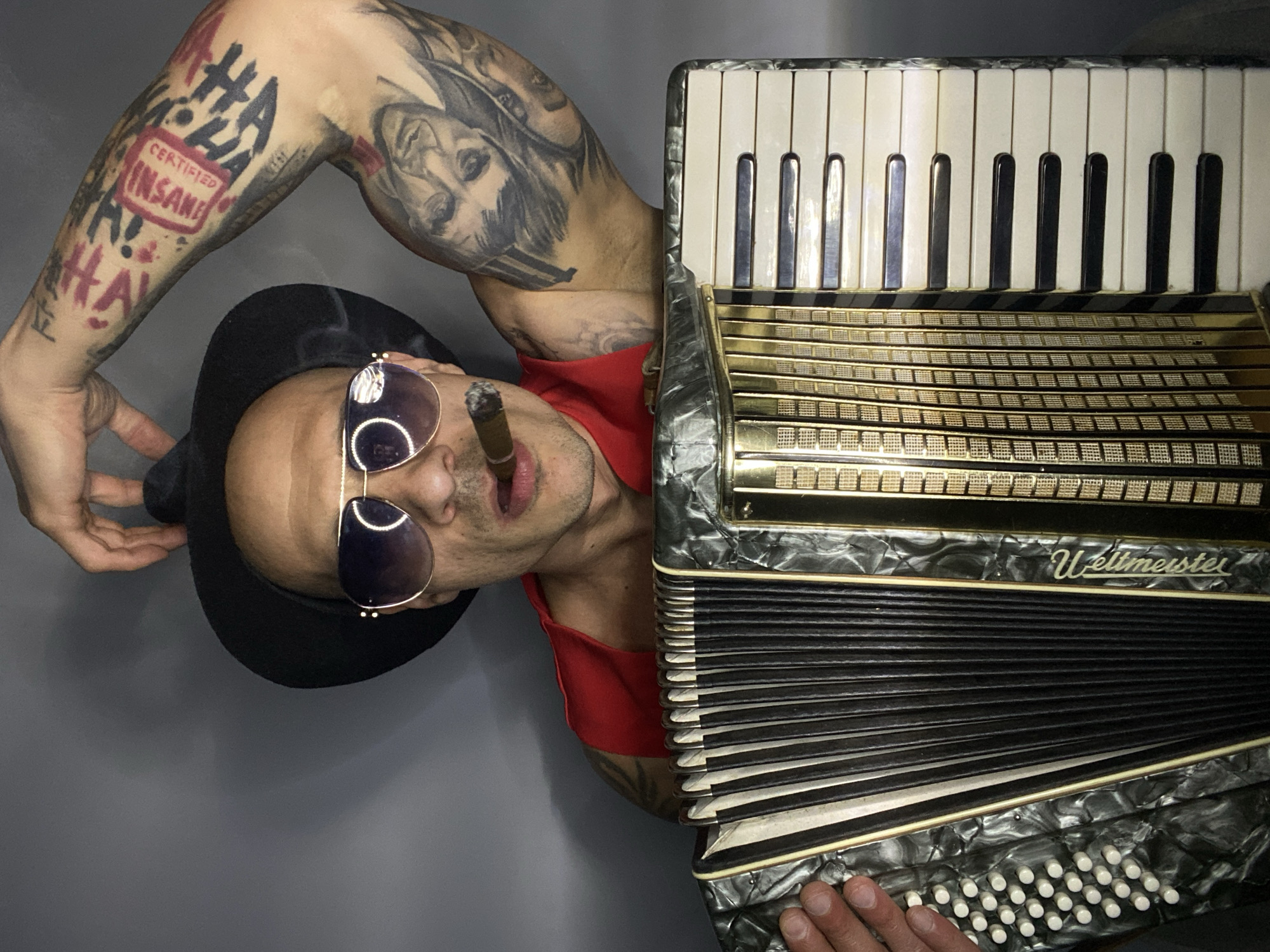 Tattooed accordion player performs with cigar in Pleven, Bulgaria