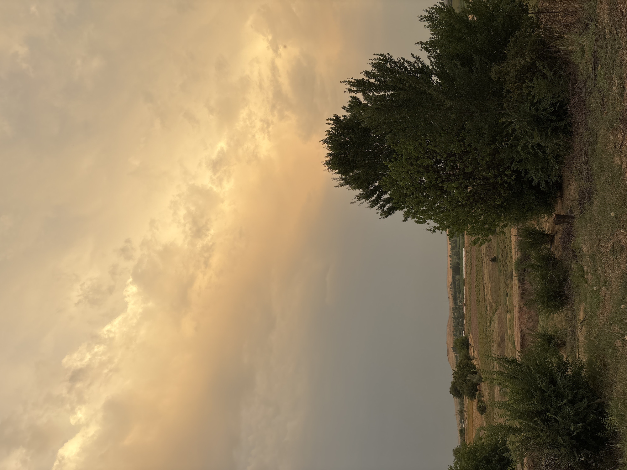 Dramatic cloud-filled skies over rural Kazakhstan at dusk