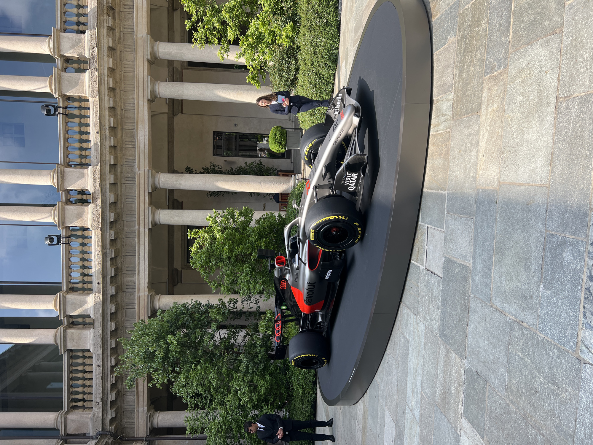 Formula 1 car displayed outside classical Milan building