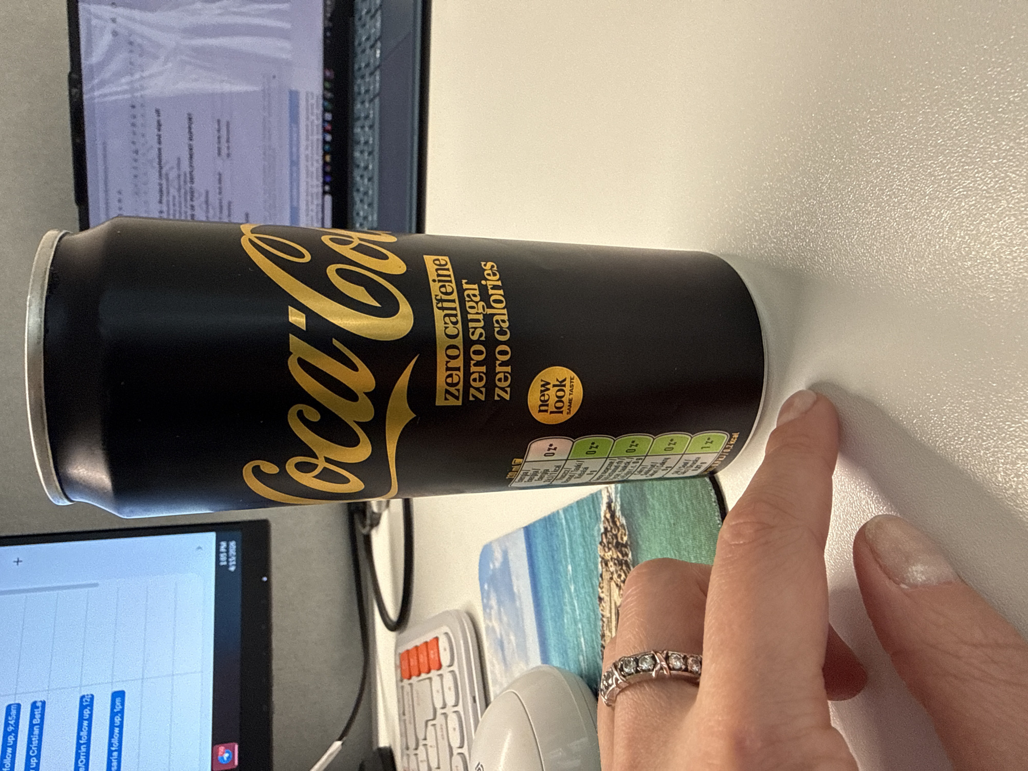 Desk snack moment captured with Coca-Cola can in Riga