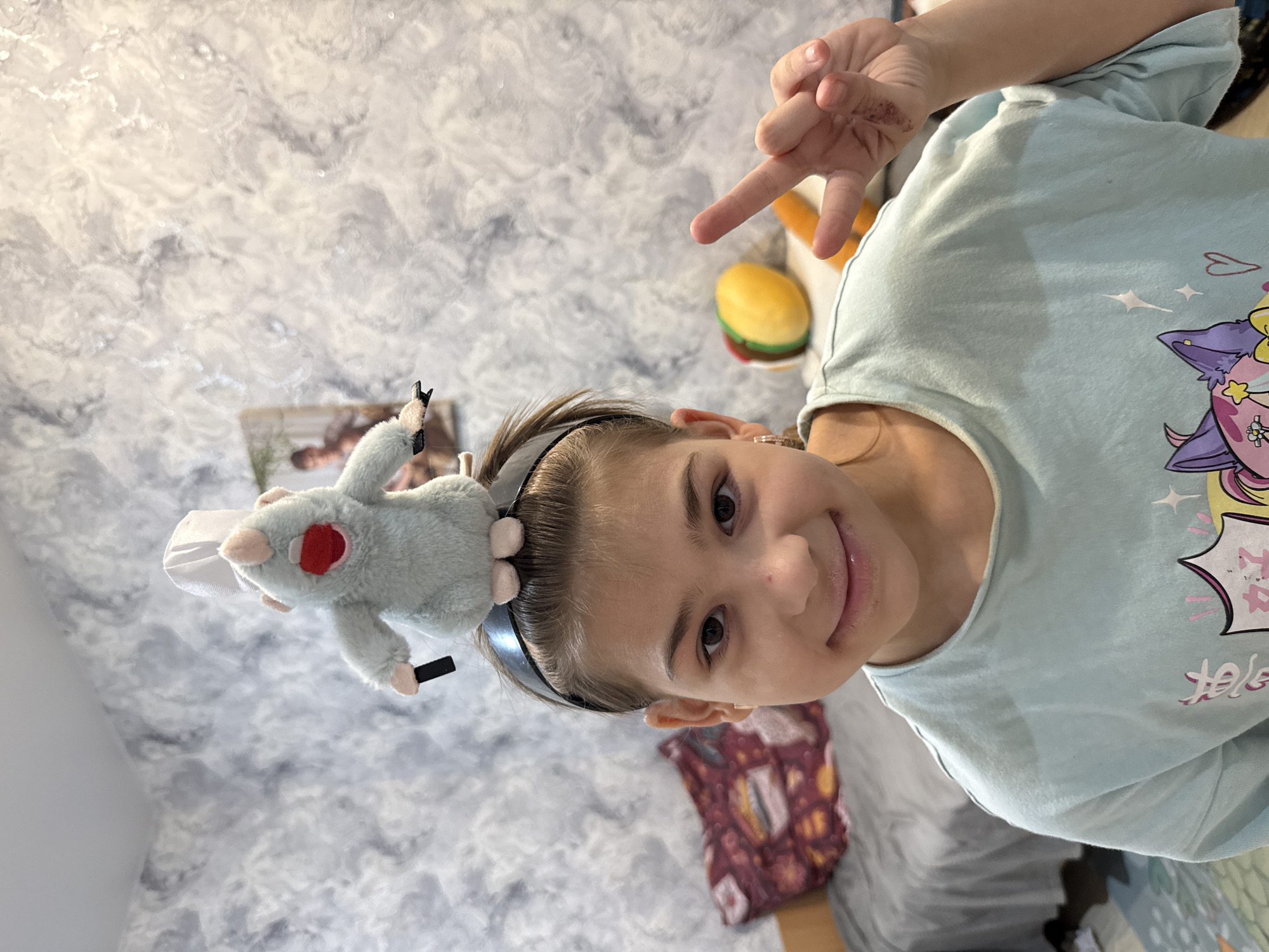 Girl in anime shirt makes peace sign in Zhukovo