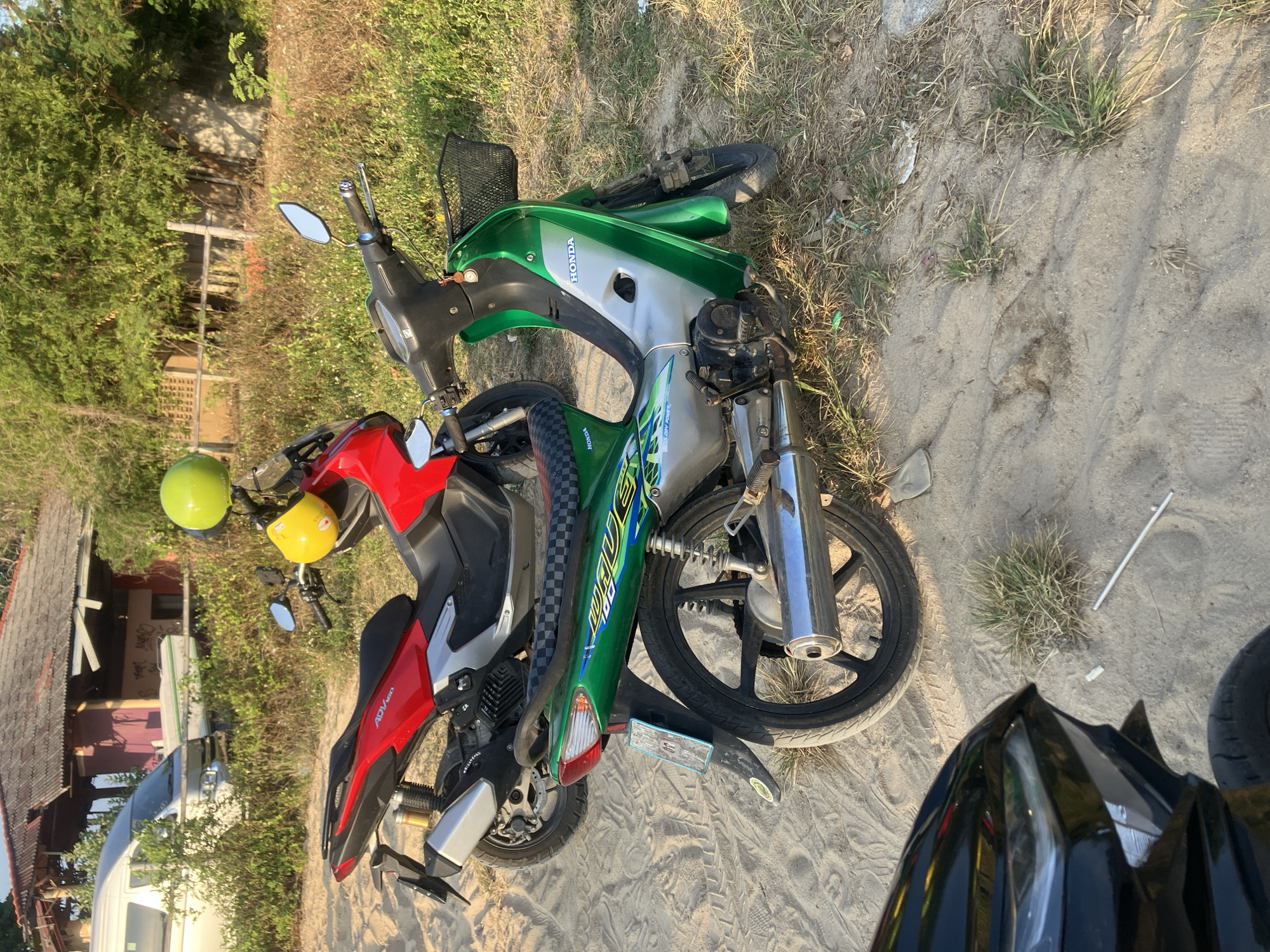 Motorcycles parked at sandy Choeng Mon beach area, Thailand