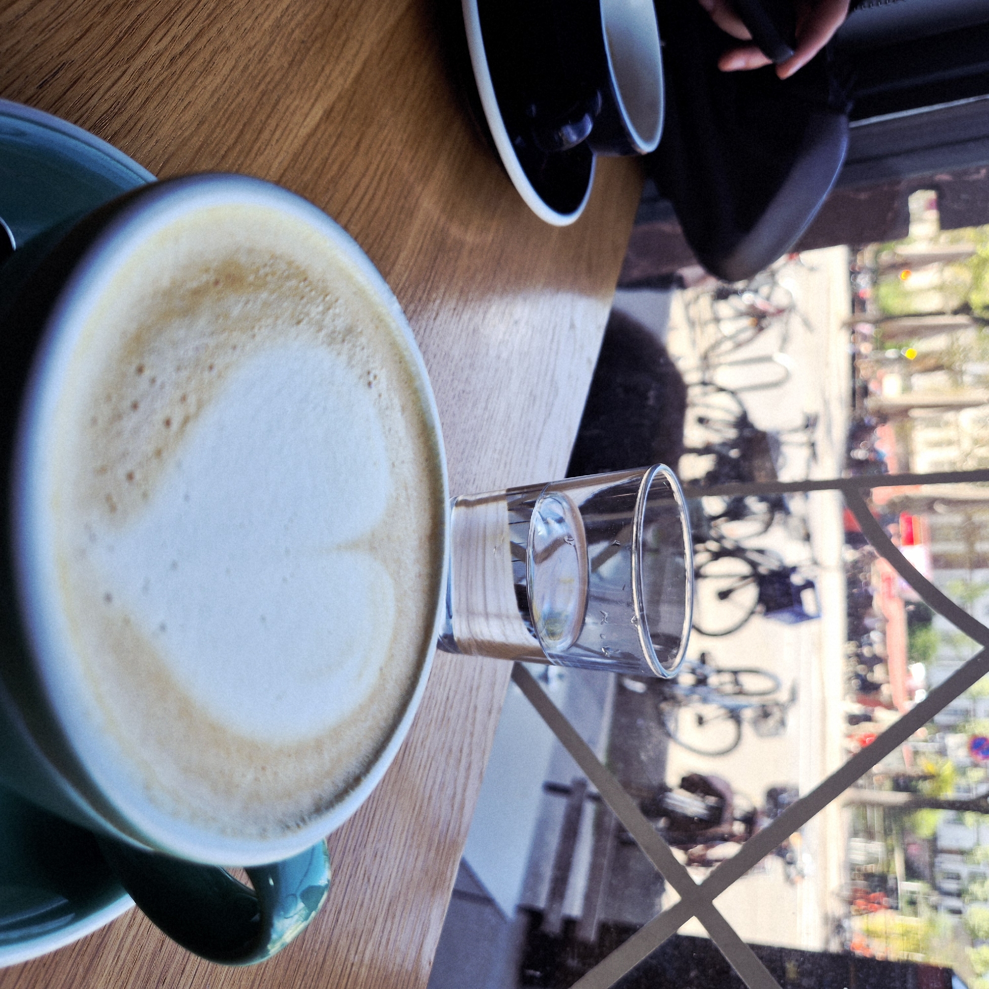 Coffee break captured at Strasbourg cafe with street view