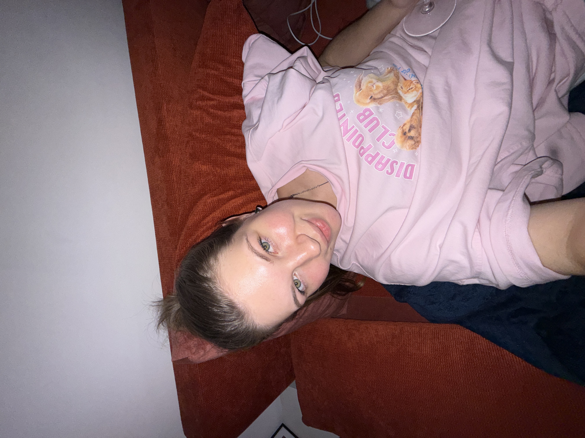 Woman takes selfie on orange sofa in Belgrade suburb