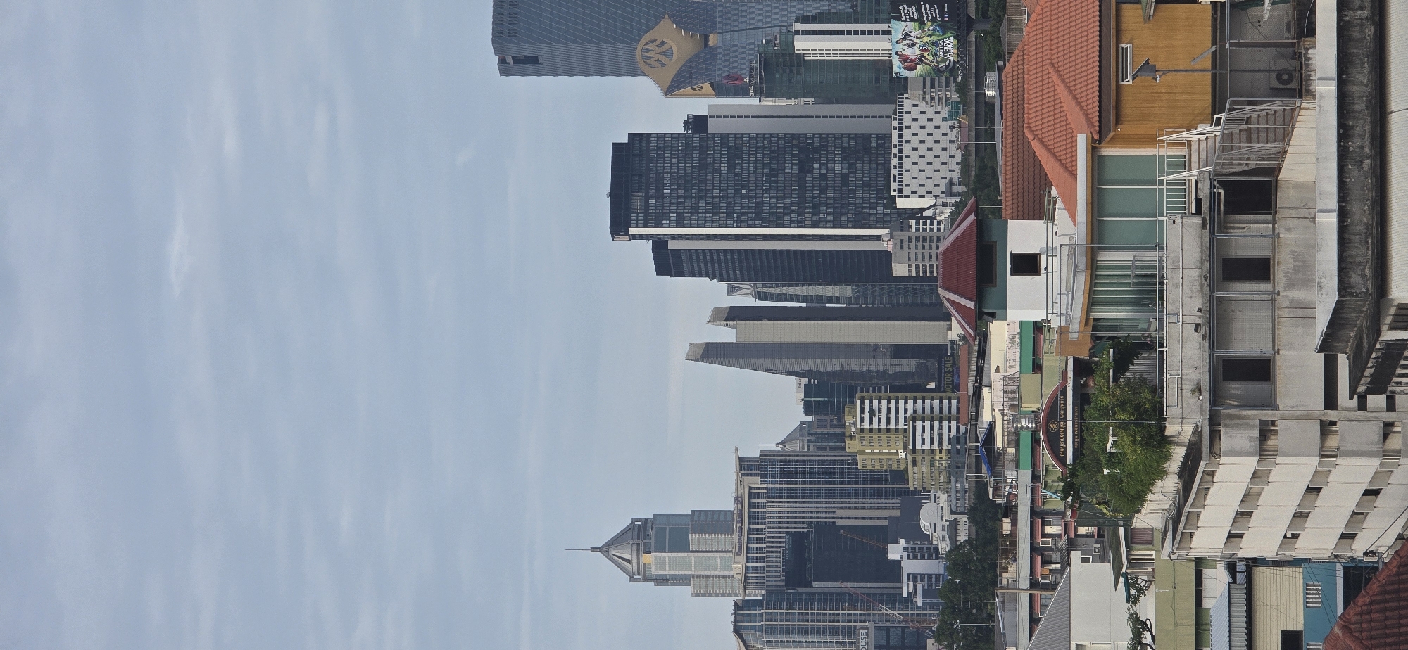 Bangkok skyline under an overcast sky, seen from above.