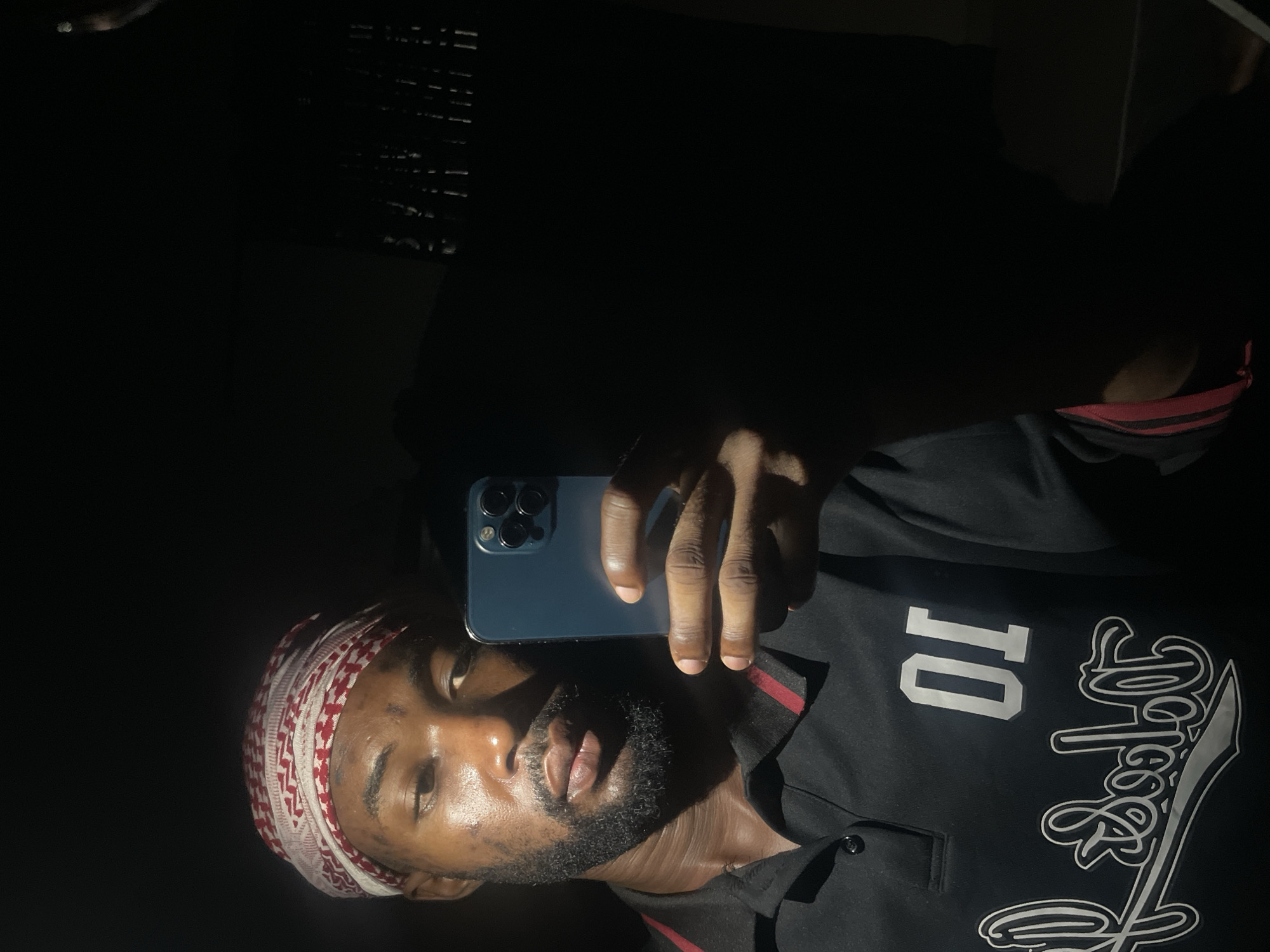 Man takes selfies in dark setting in Lokoja, Nigeria