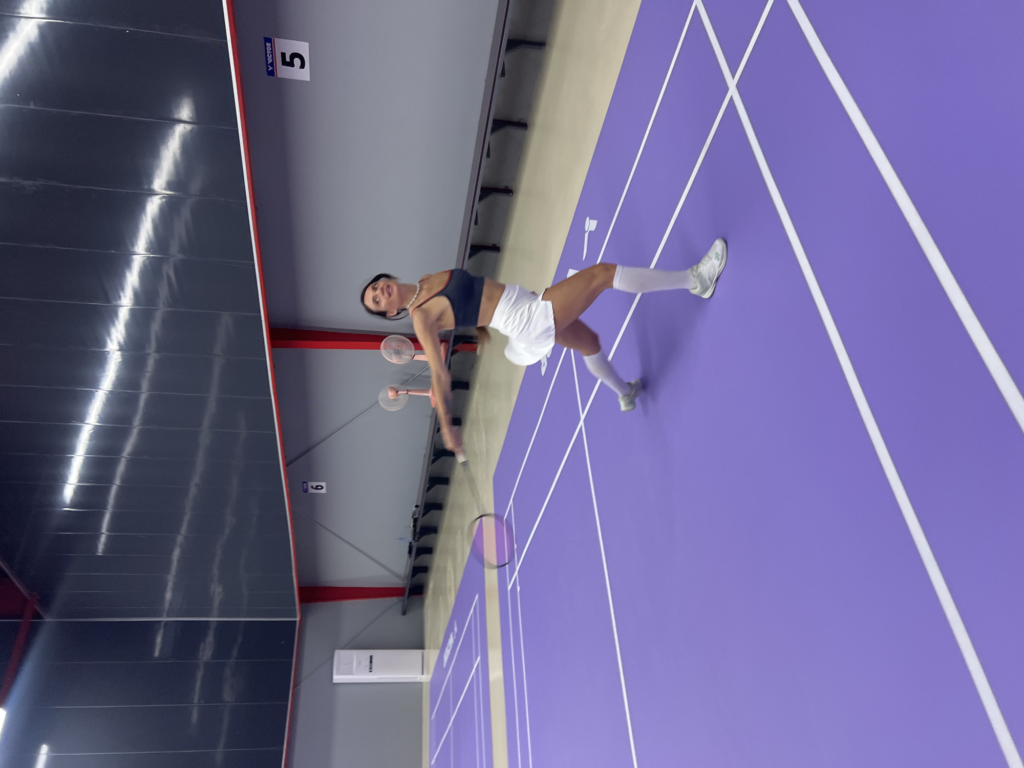 Woman plays badminton on indoor court in Ko Samui