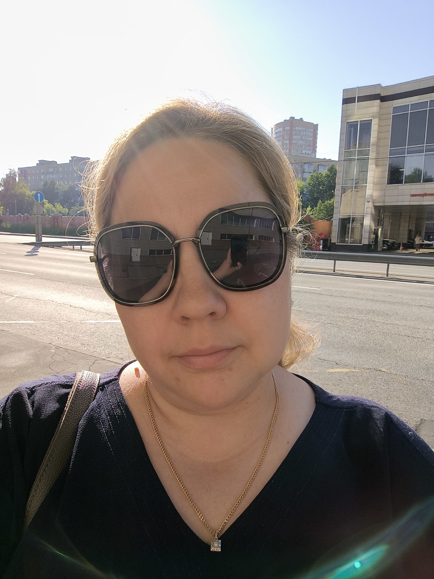 Woman takes early morning selfie on Moscow sidewalk