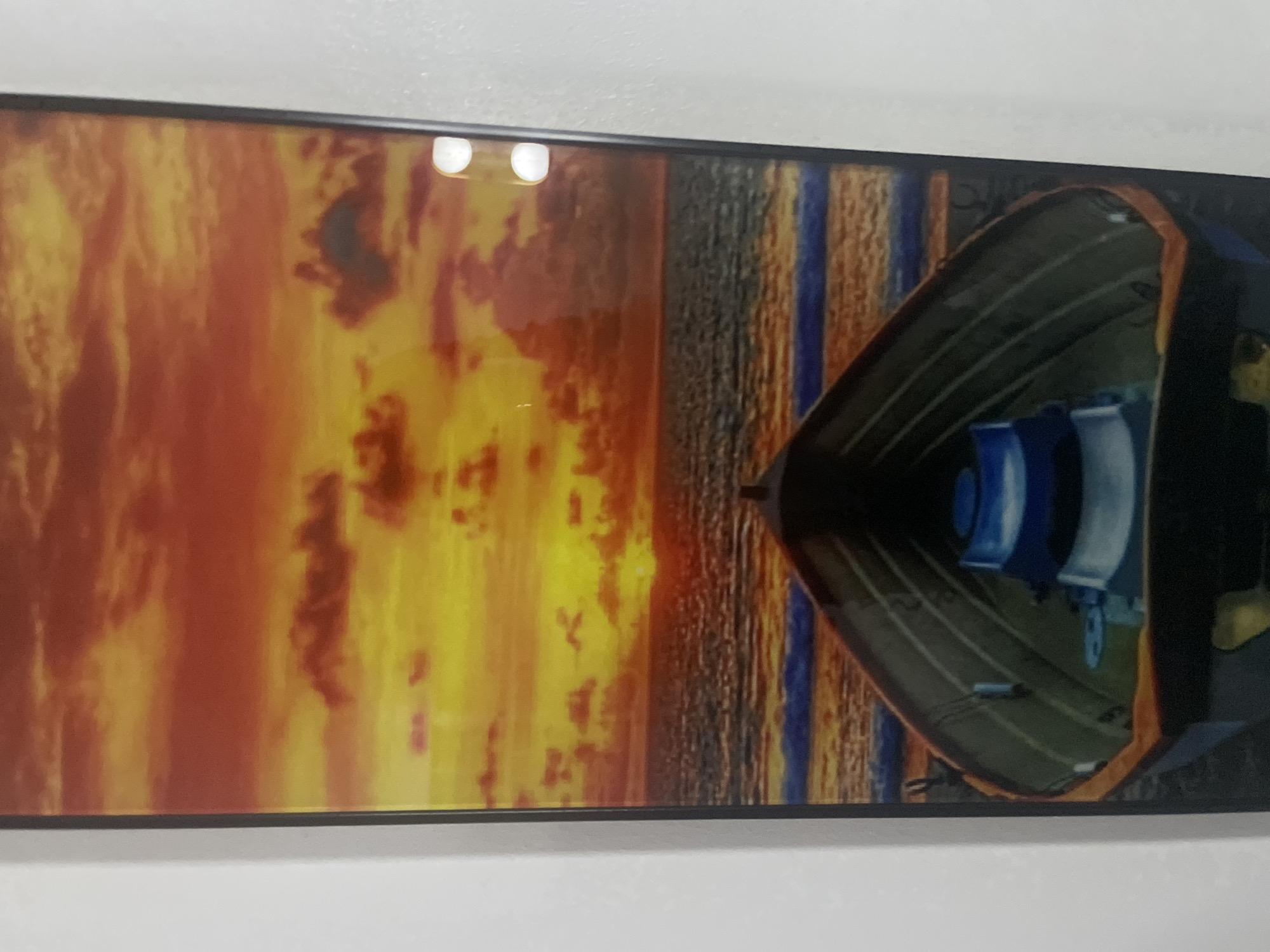 Four landscape and seascape artworks displayed on walls in Abuja