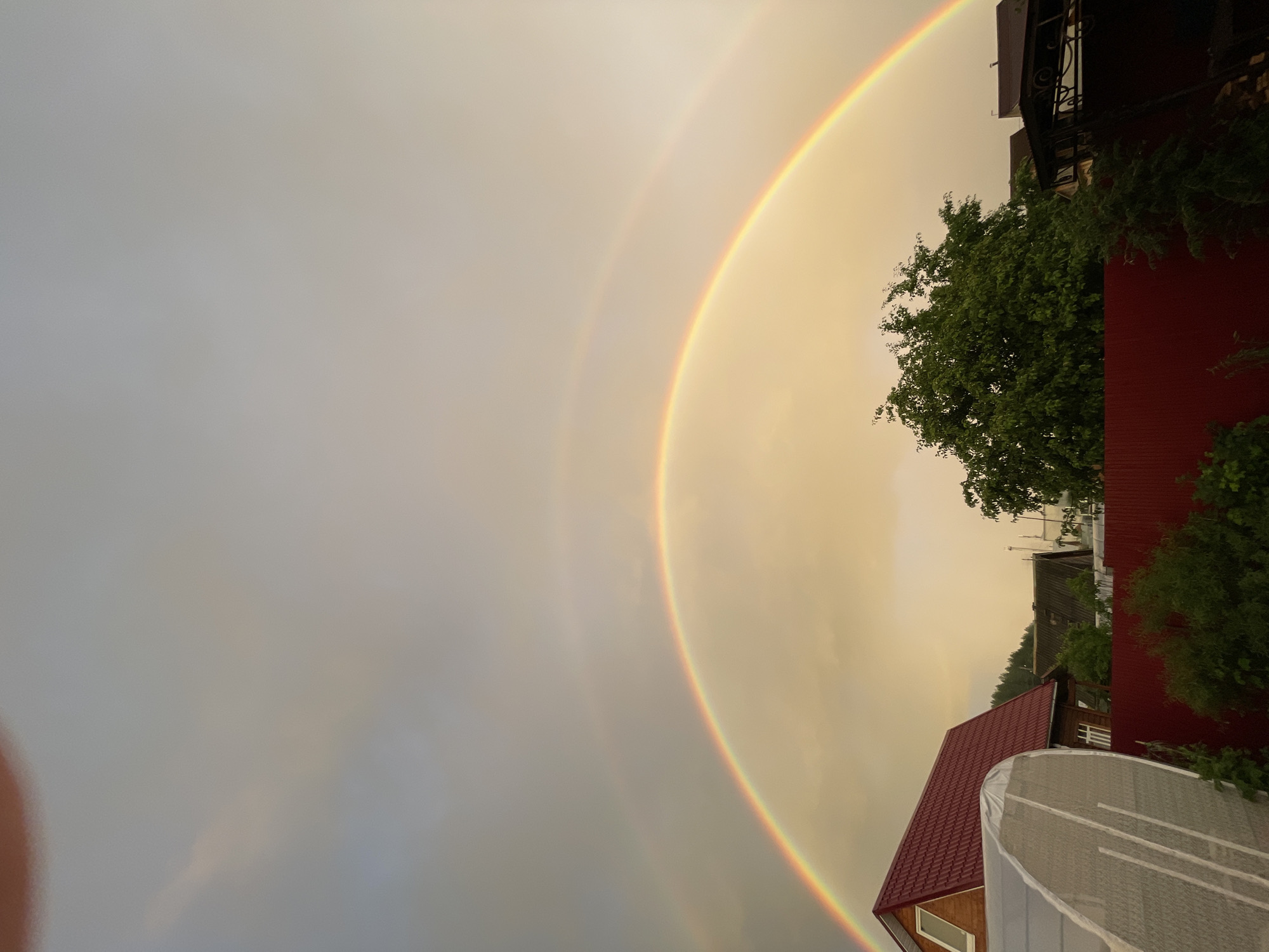 Double rainbow over a rural sunset landscape