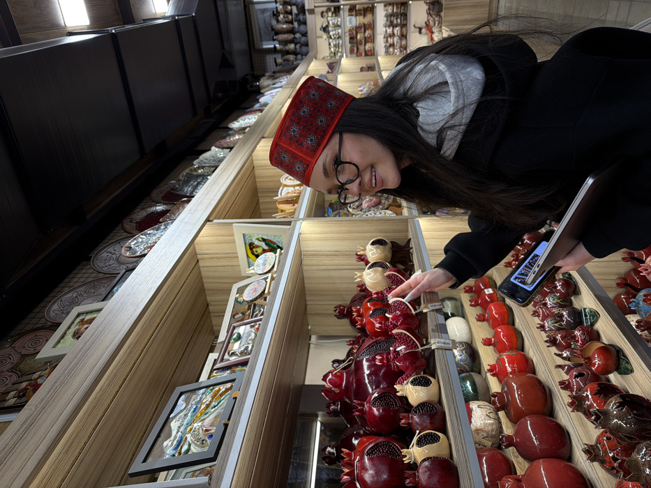 Tattooed visitor shops traditional Armenian crafts at Yerevan market