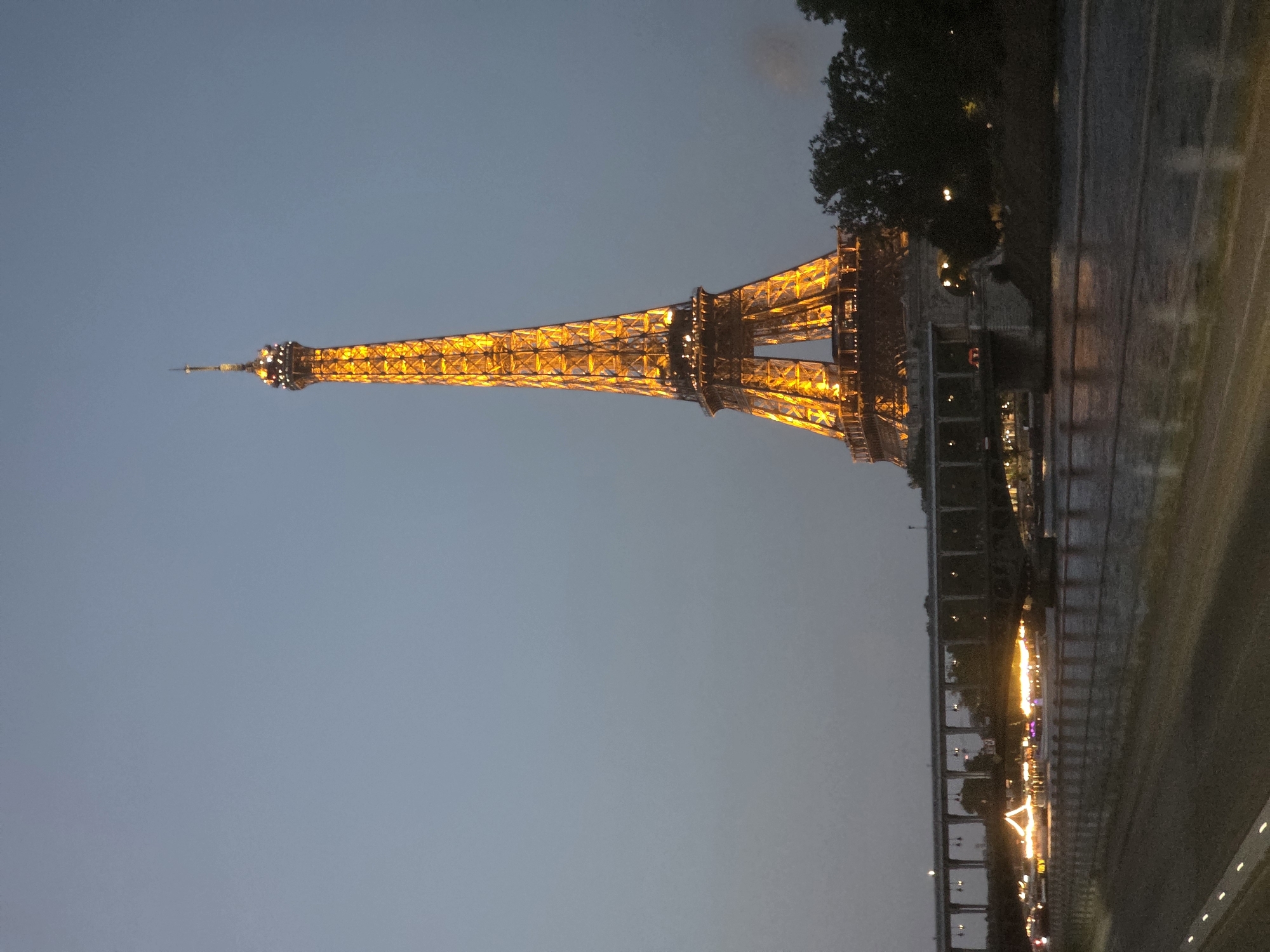 Eiffel Tower glowing gold at dusk, Paris