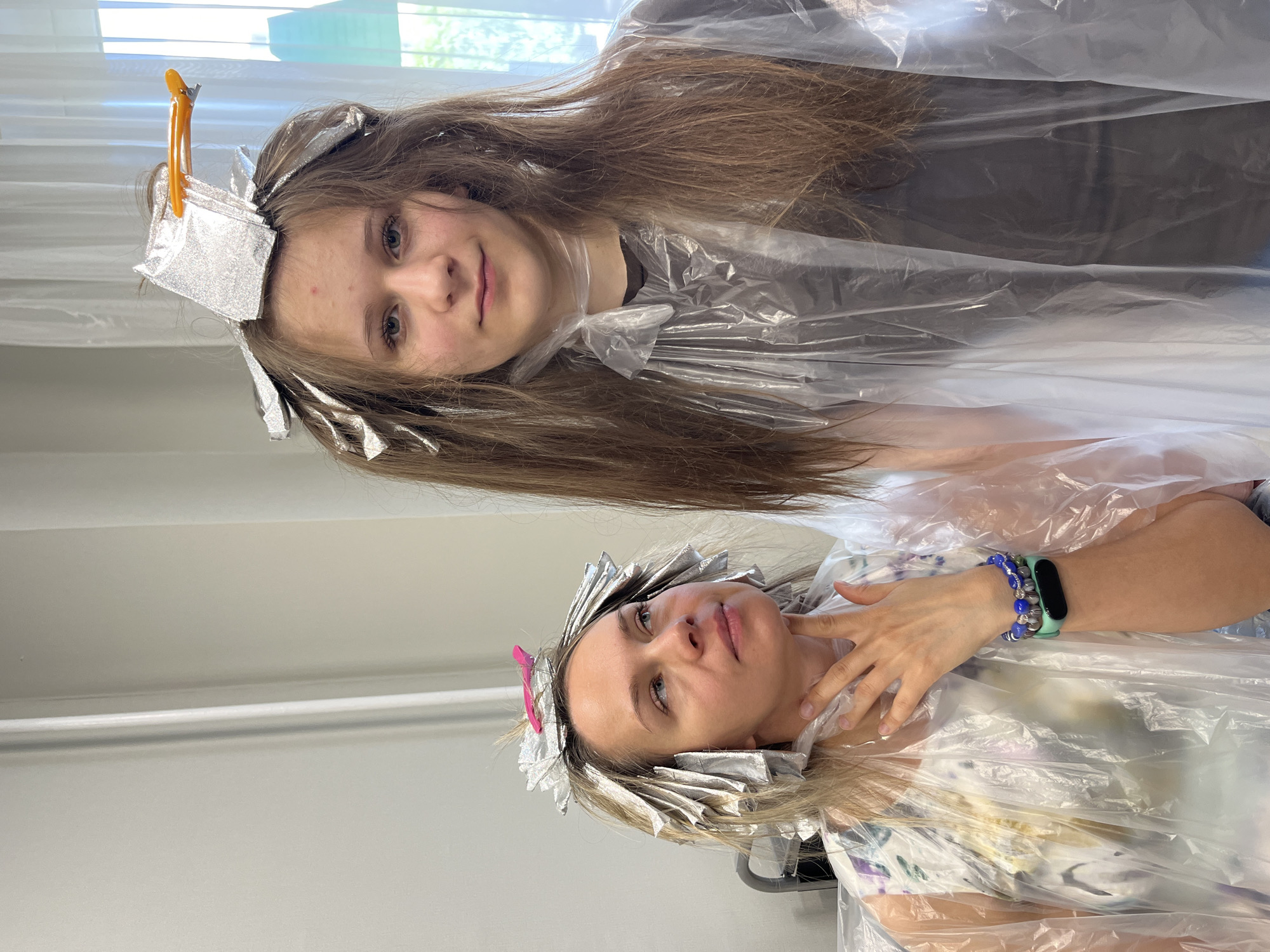 Mother and daughter get hair treatments in Dubovoye, Russia