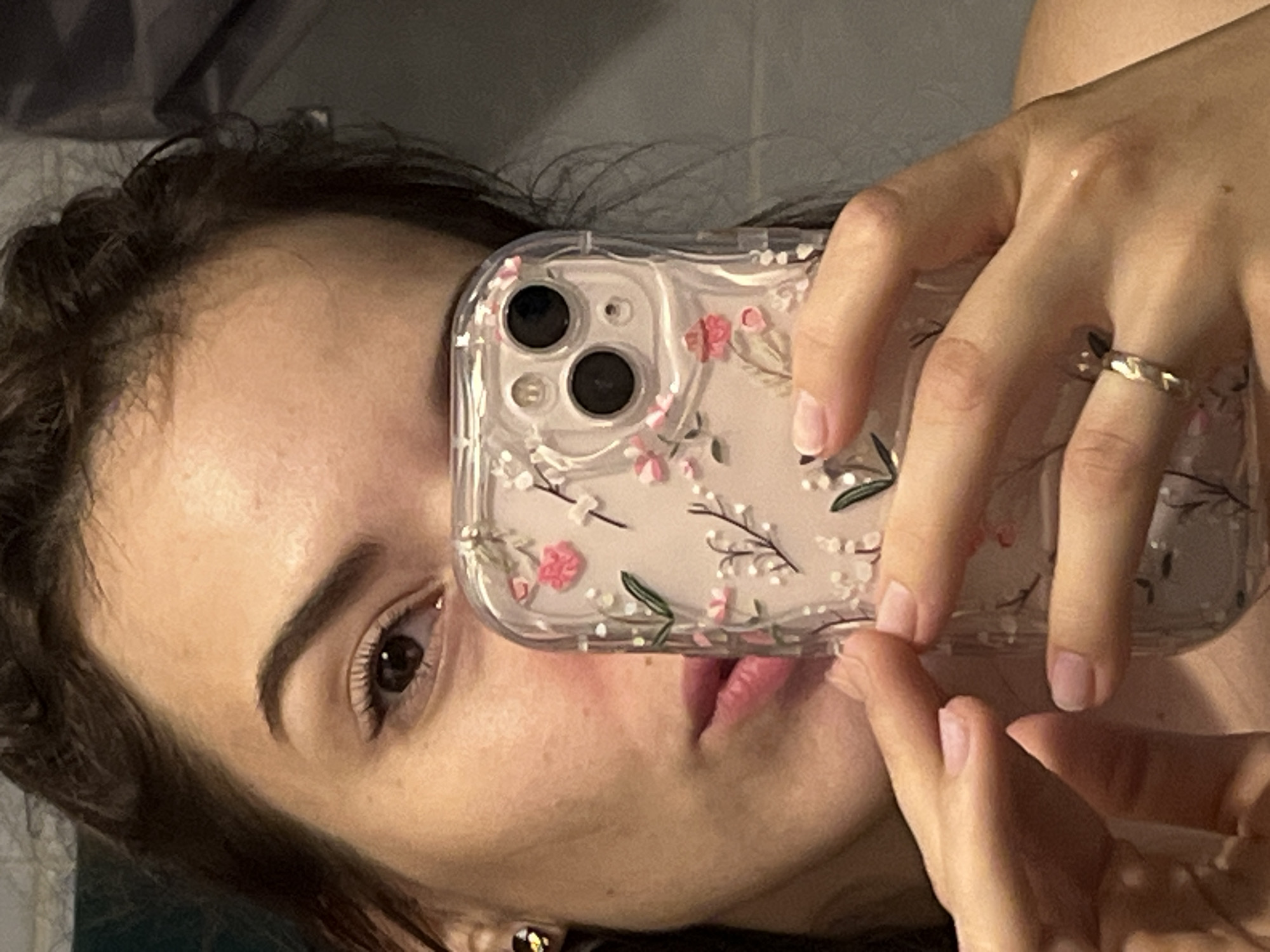 Woman takes selfies with floral phone case in Shushary