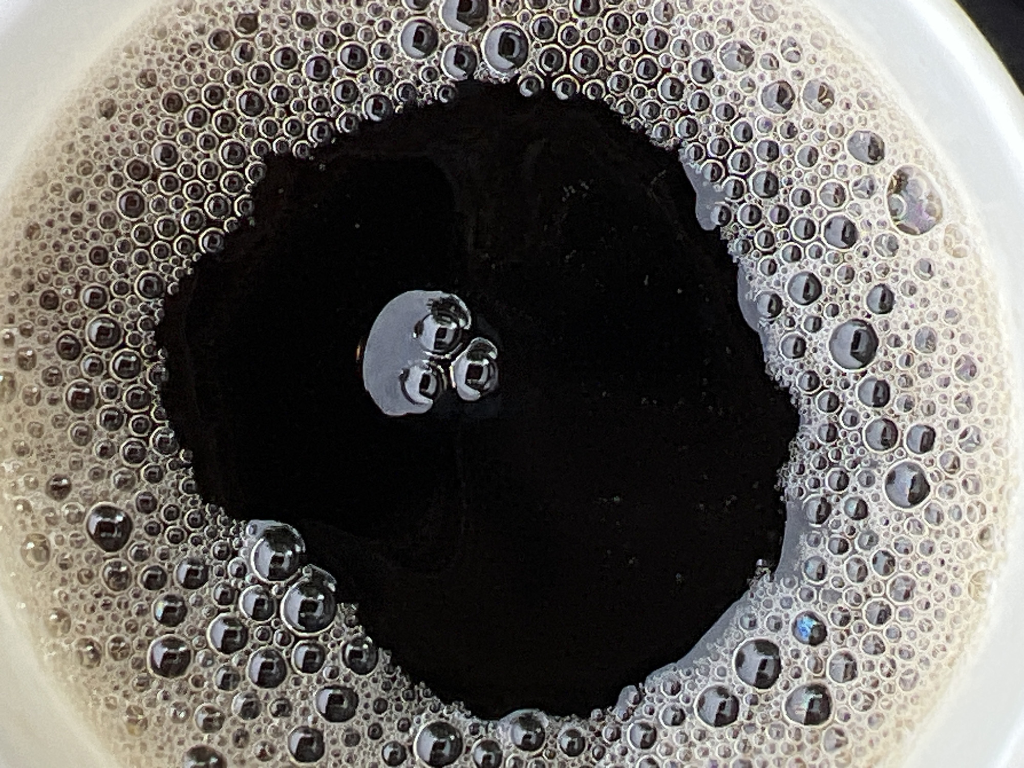 Overhead close-up of a foamy black coffee in Ukraine