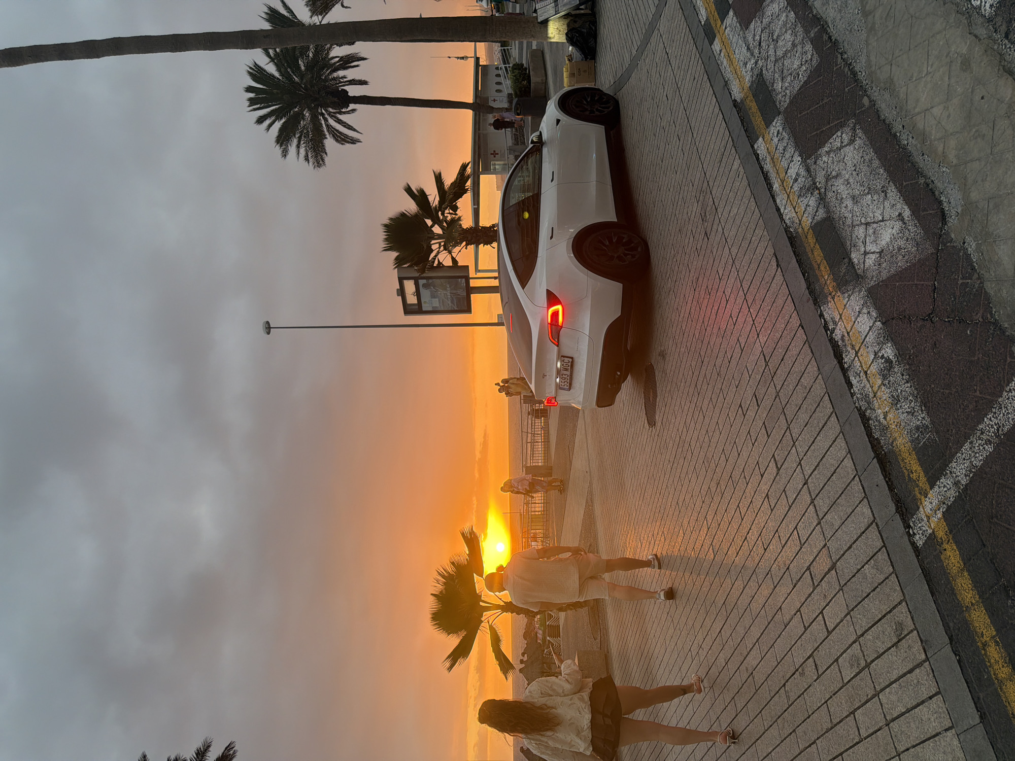 Couple shares sunset kiss on Adeje promenade