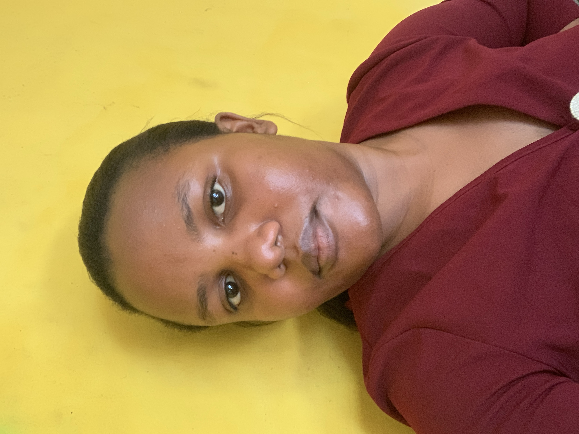 Woman photographed in casual indoor poses in Dar es-Salaam