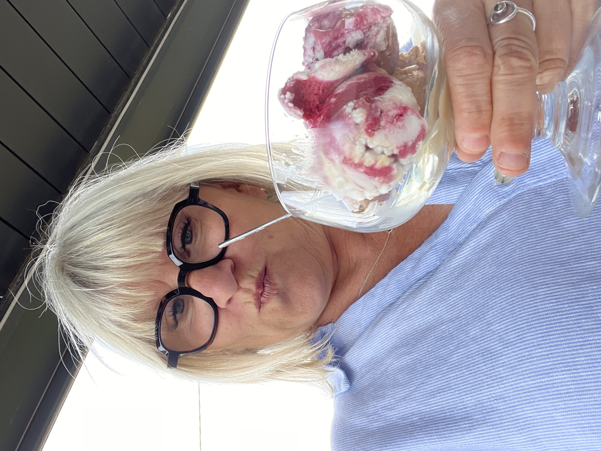 Woman enjoys ice cream during afternoon treat in French town