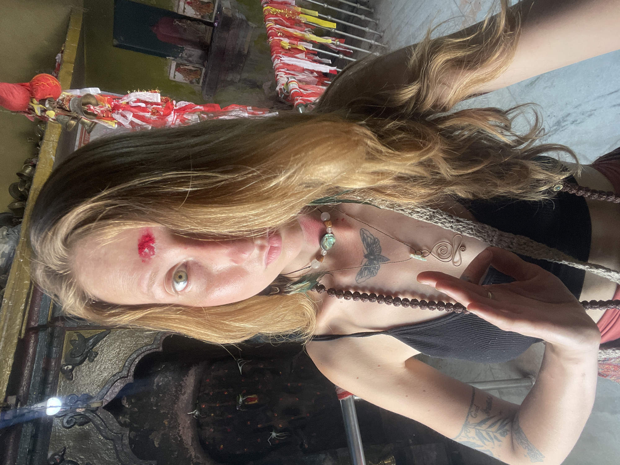 Woman photographs herself at Hindu temple in Nepal