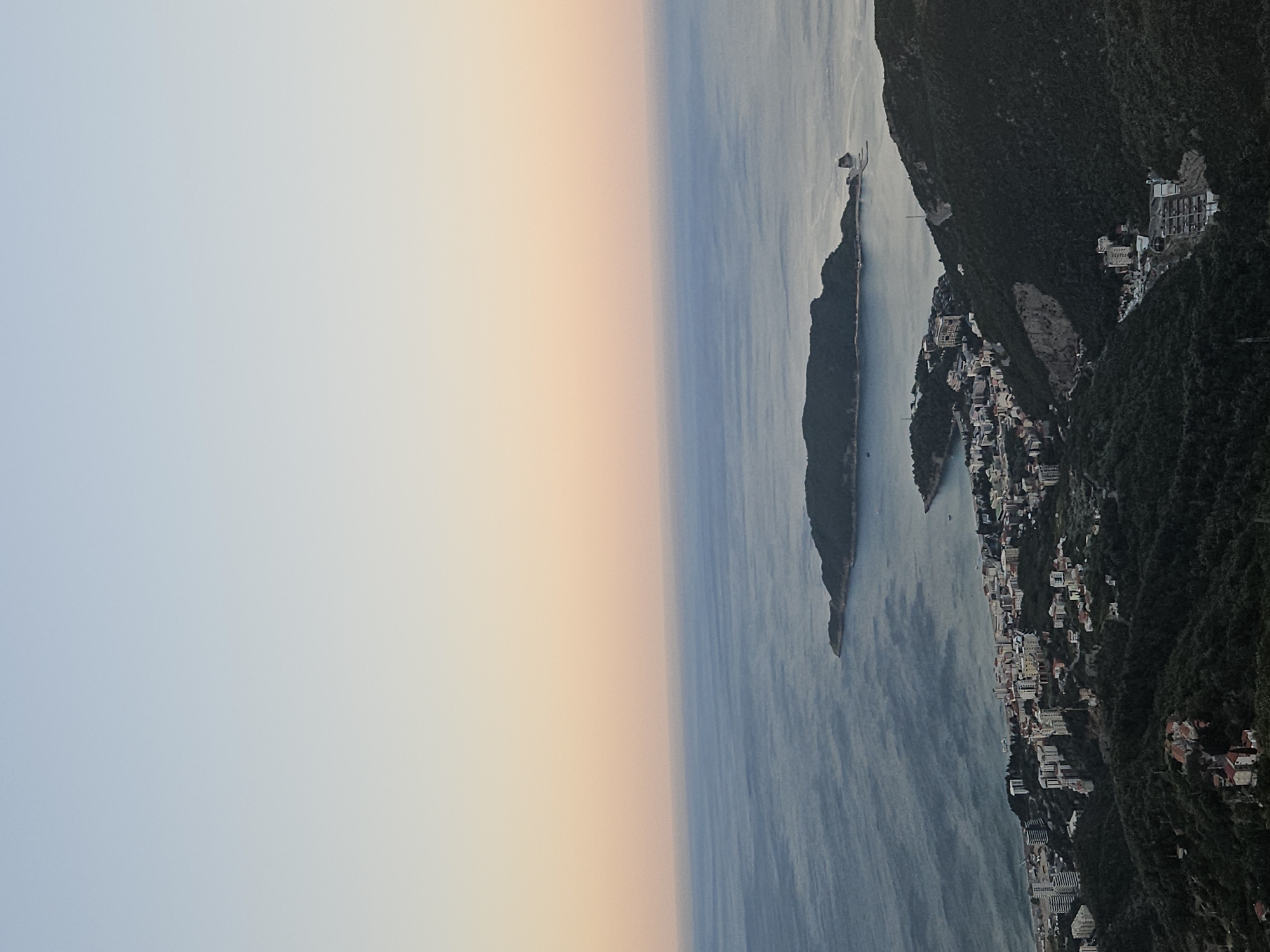 Budva's coastline at dusk, layered sky and sea.