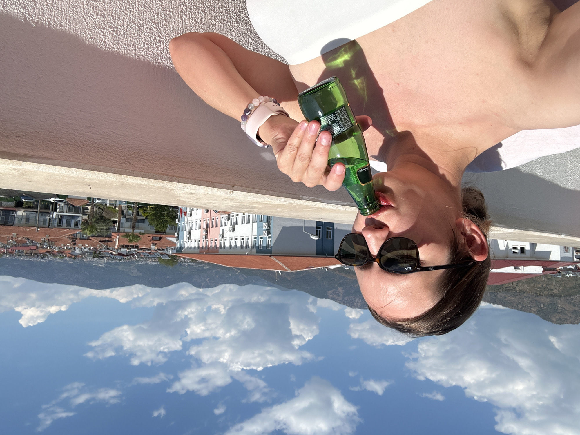Woman enjoys morning routine on Fethiye balcony