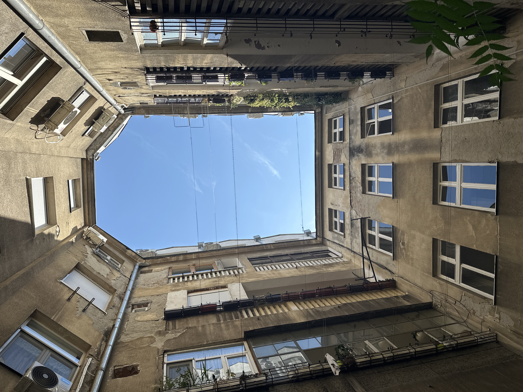 Looking up through a weathered Belgrade courtyard