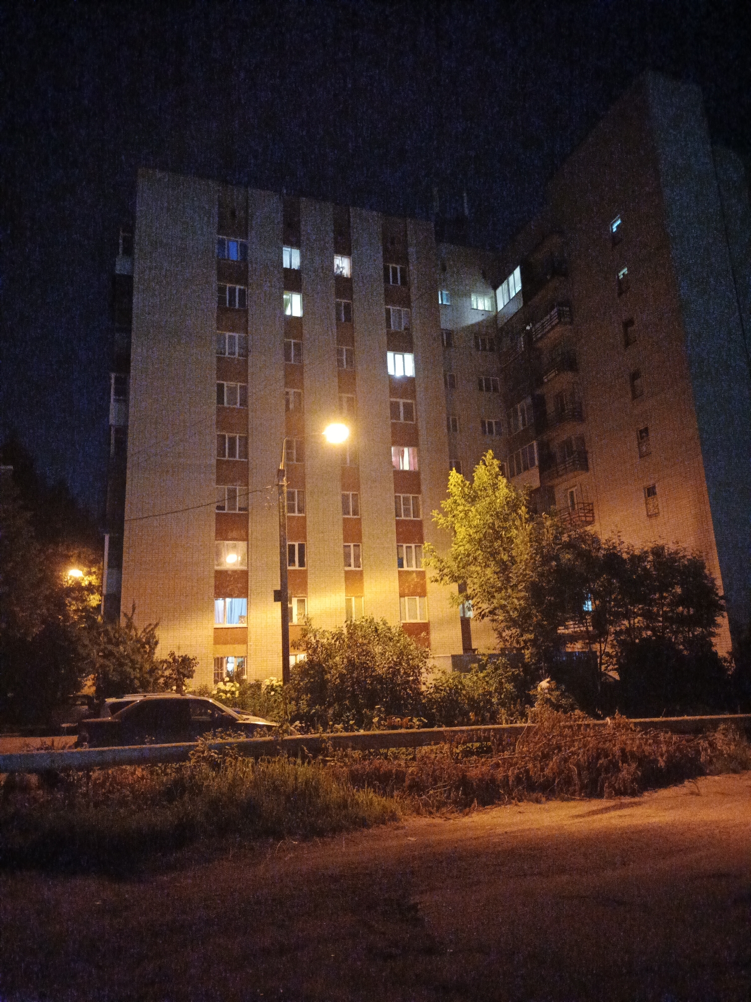 Smolensk residential streets at night, plus a lone daisy
