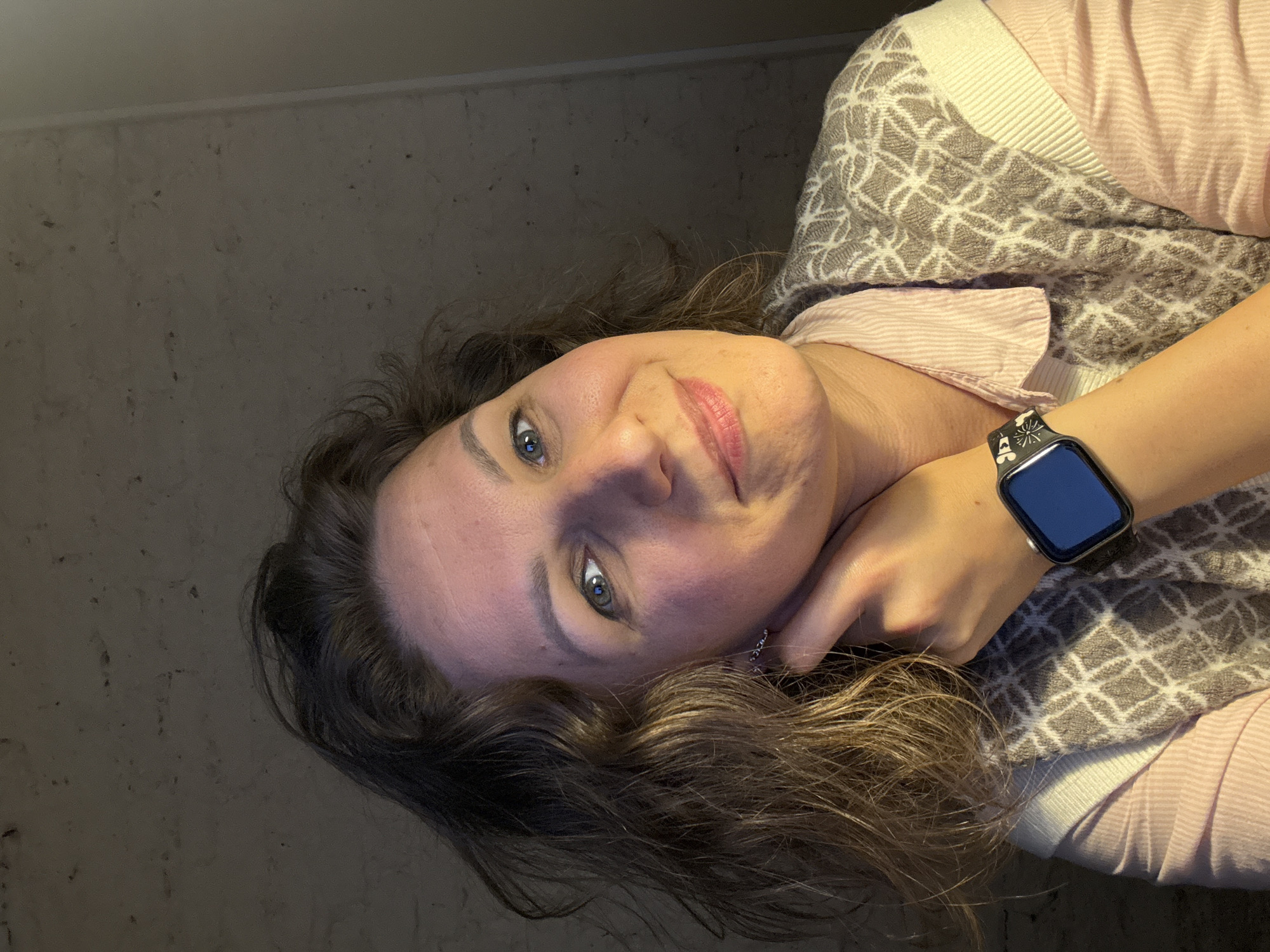 Woman photographed indoors in Saint Petersburg wearing pink shirt