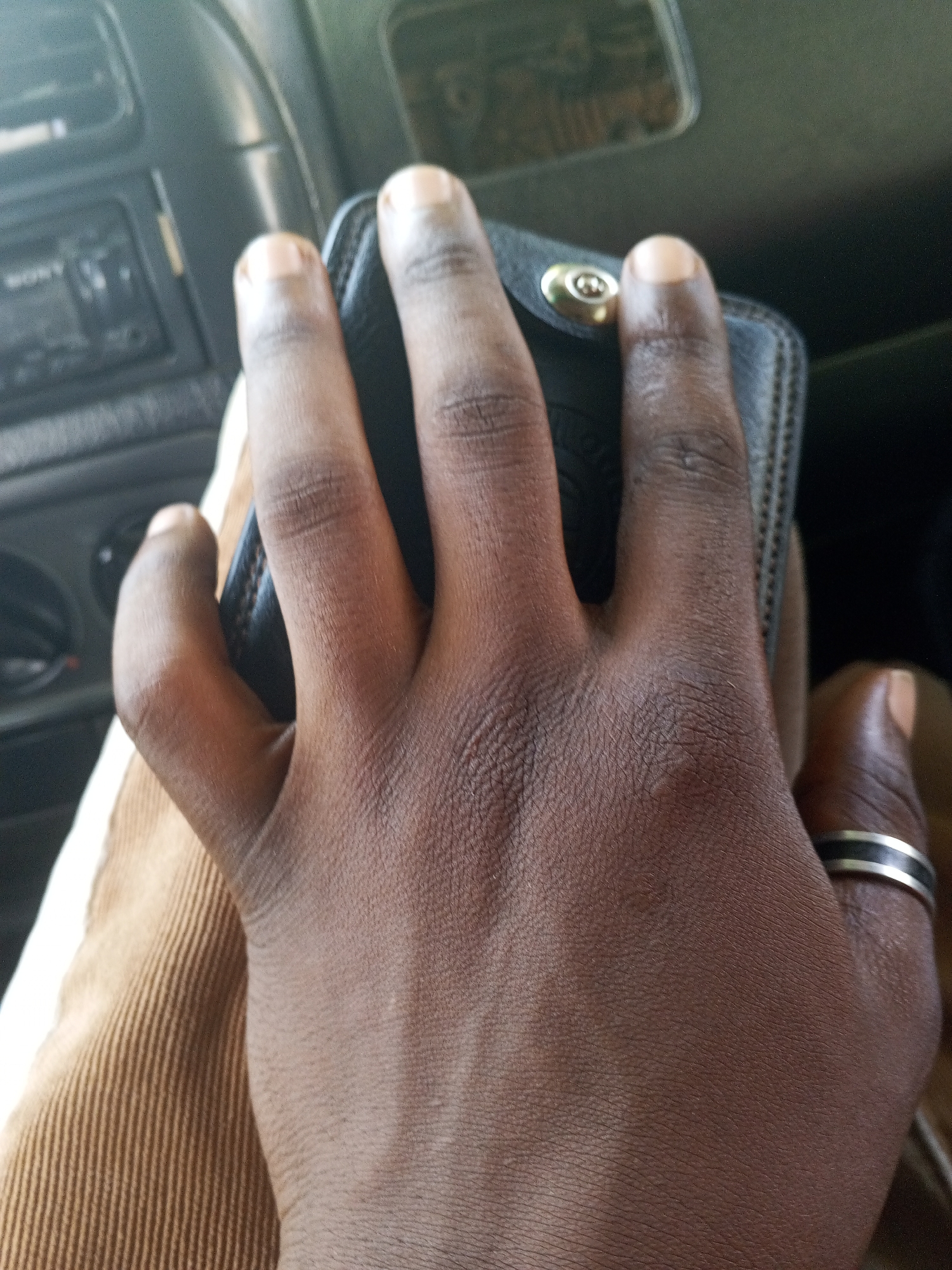 Wallet in hand, street view from a car in Abuja