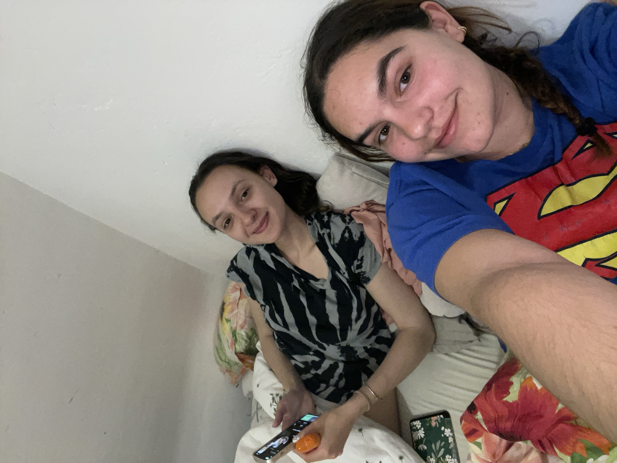 Two women take selfie in decorated indoor space