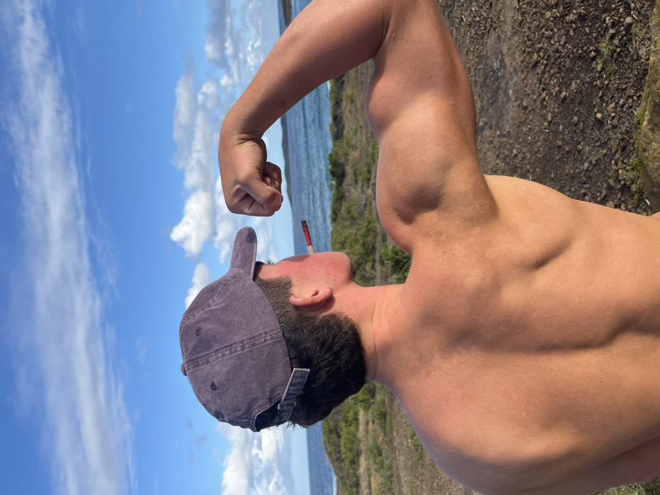Man poses shirtless at Bawley Point waterfront