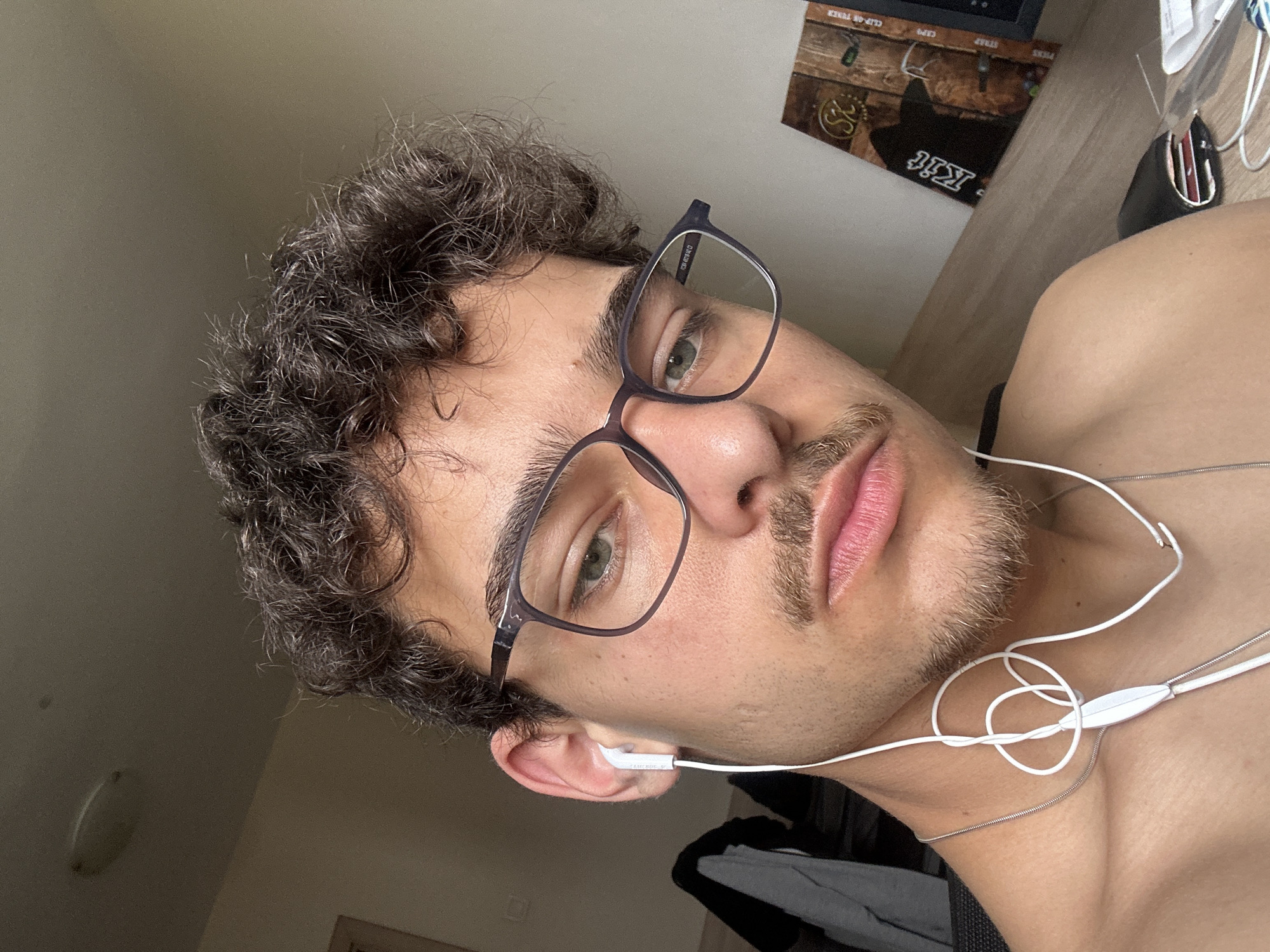 Young man observed at desk setup in Sofia bedroom