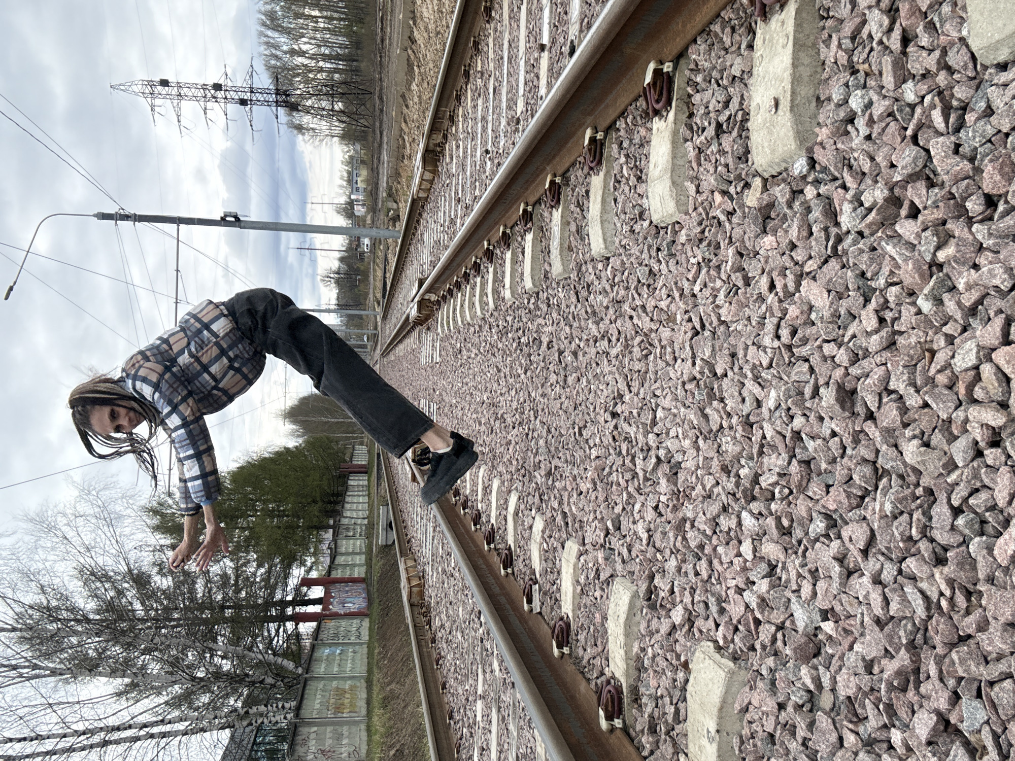Person poses on railway tracks, takes transport selfies in Russia