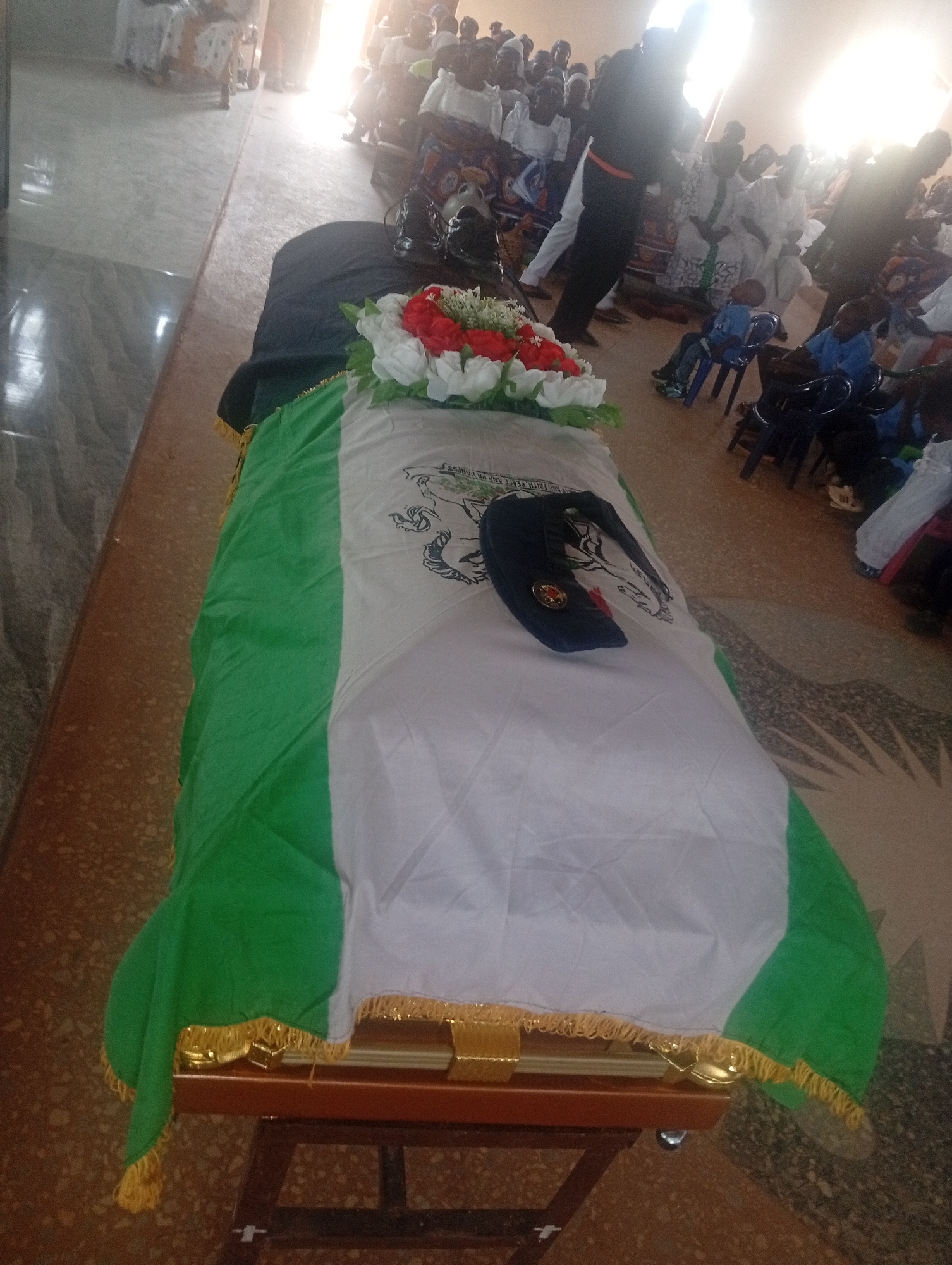 Funeral service held with flag-draped casket and ceremonial proceedings