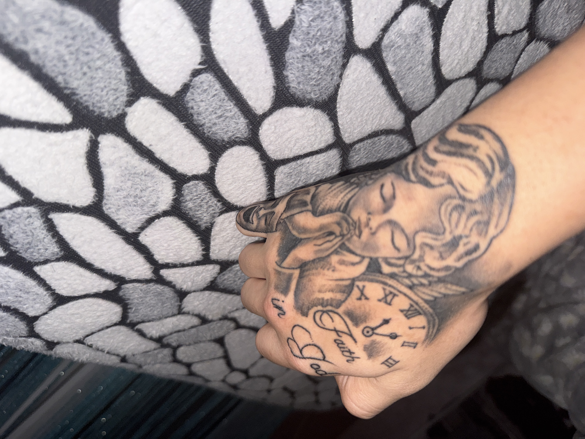 Person displays religious tattoos in intimate photo session
