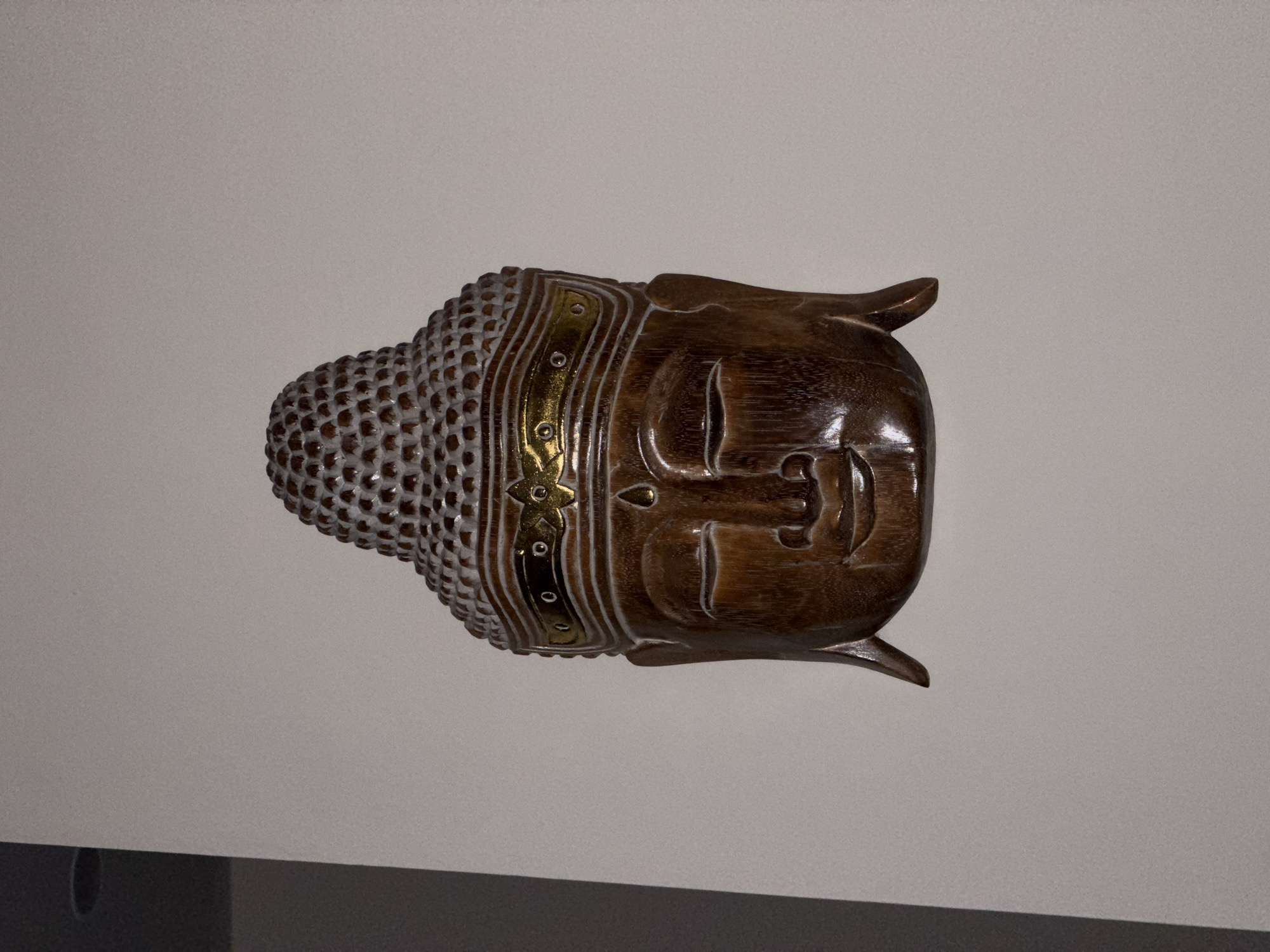 Decorative Buddha sculpture observed on wall in Kalibukbuk, Indonesia