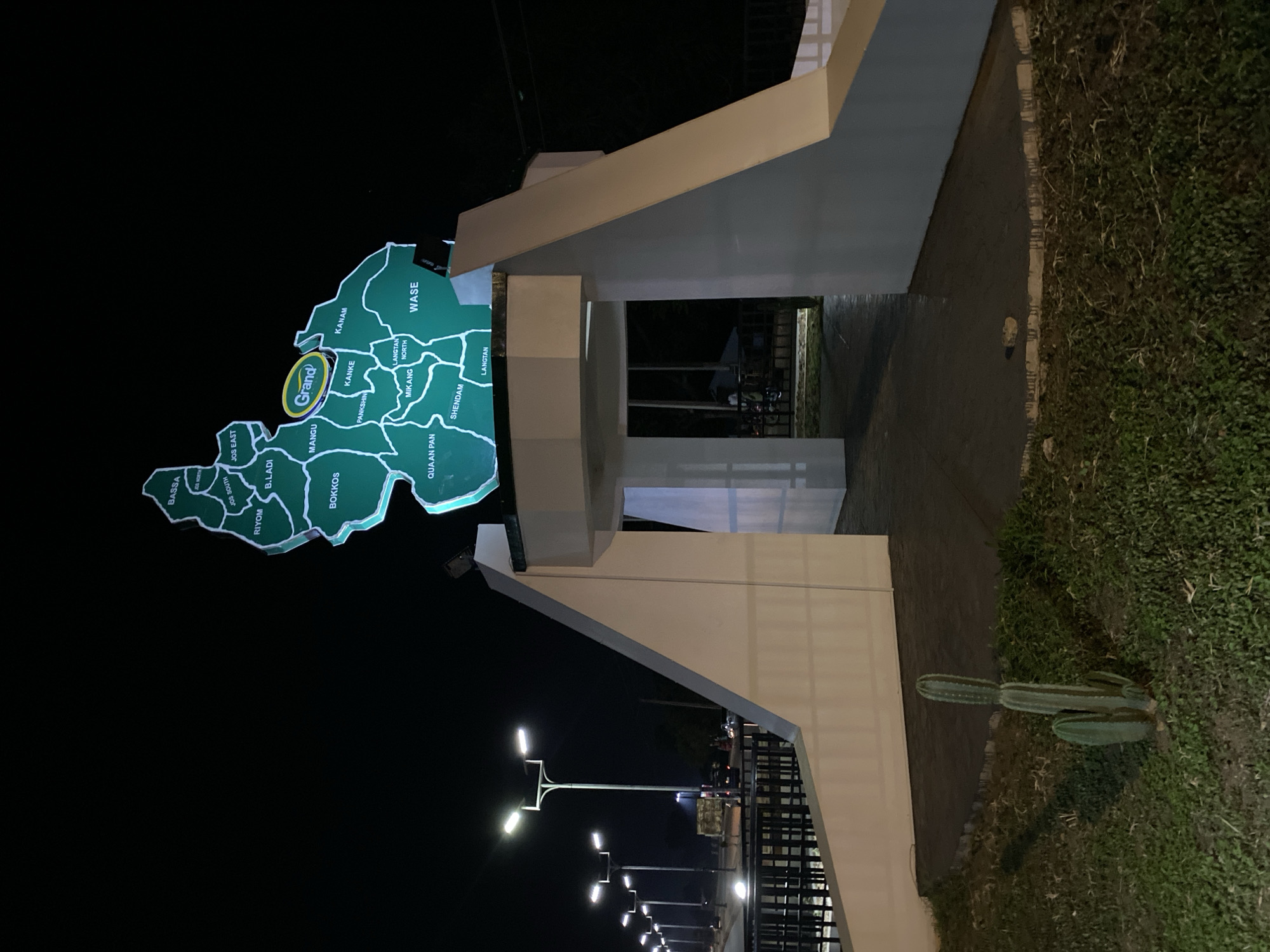 Night scenes around Bukuru's lit roundabout monument and surrounding streets